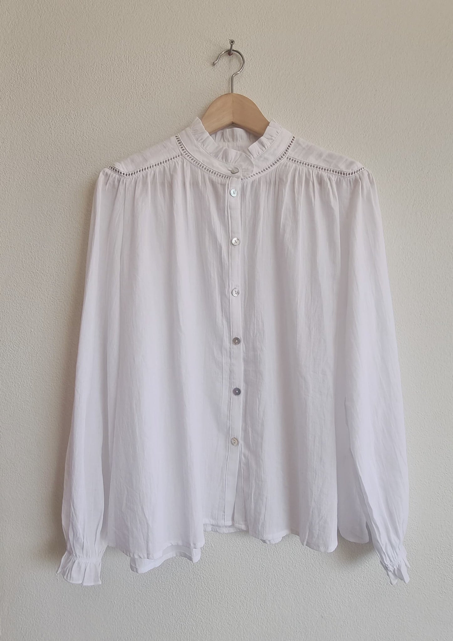 White 100% cotton blouse hanging front view