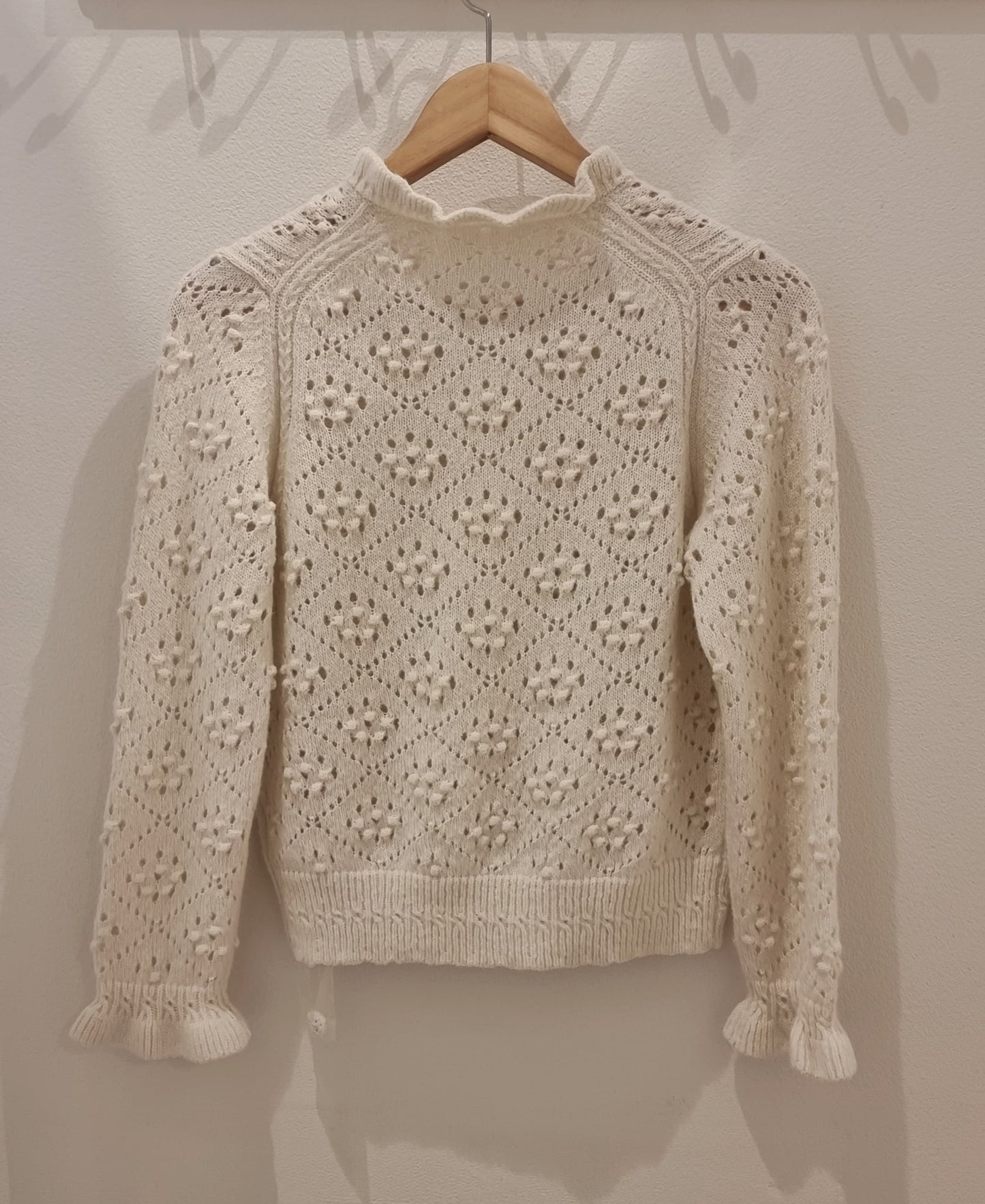 Back view of cream alpaca blend textured knit cardigan