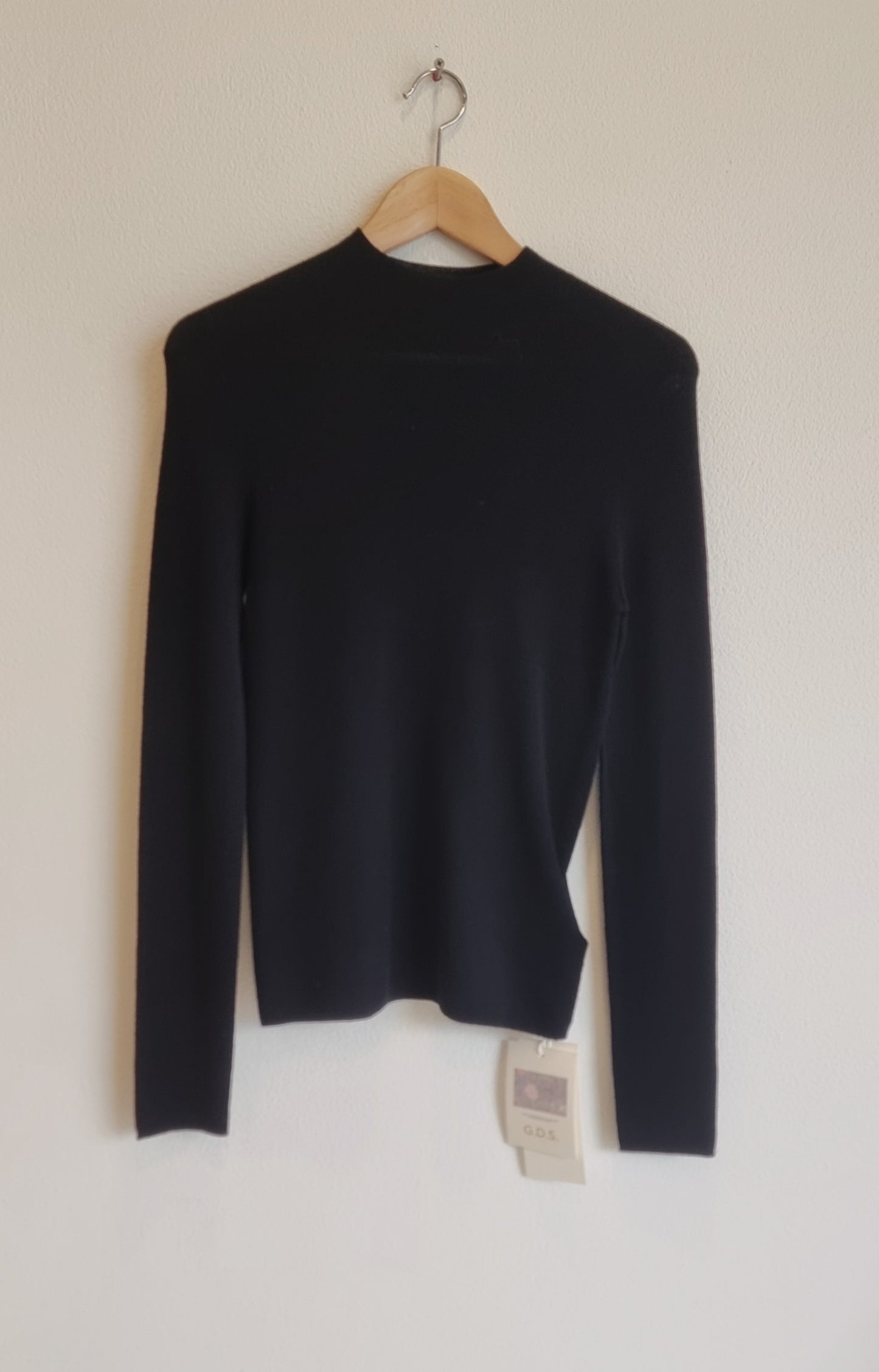 Black wool sweater on hanger