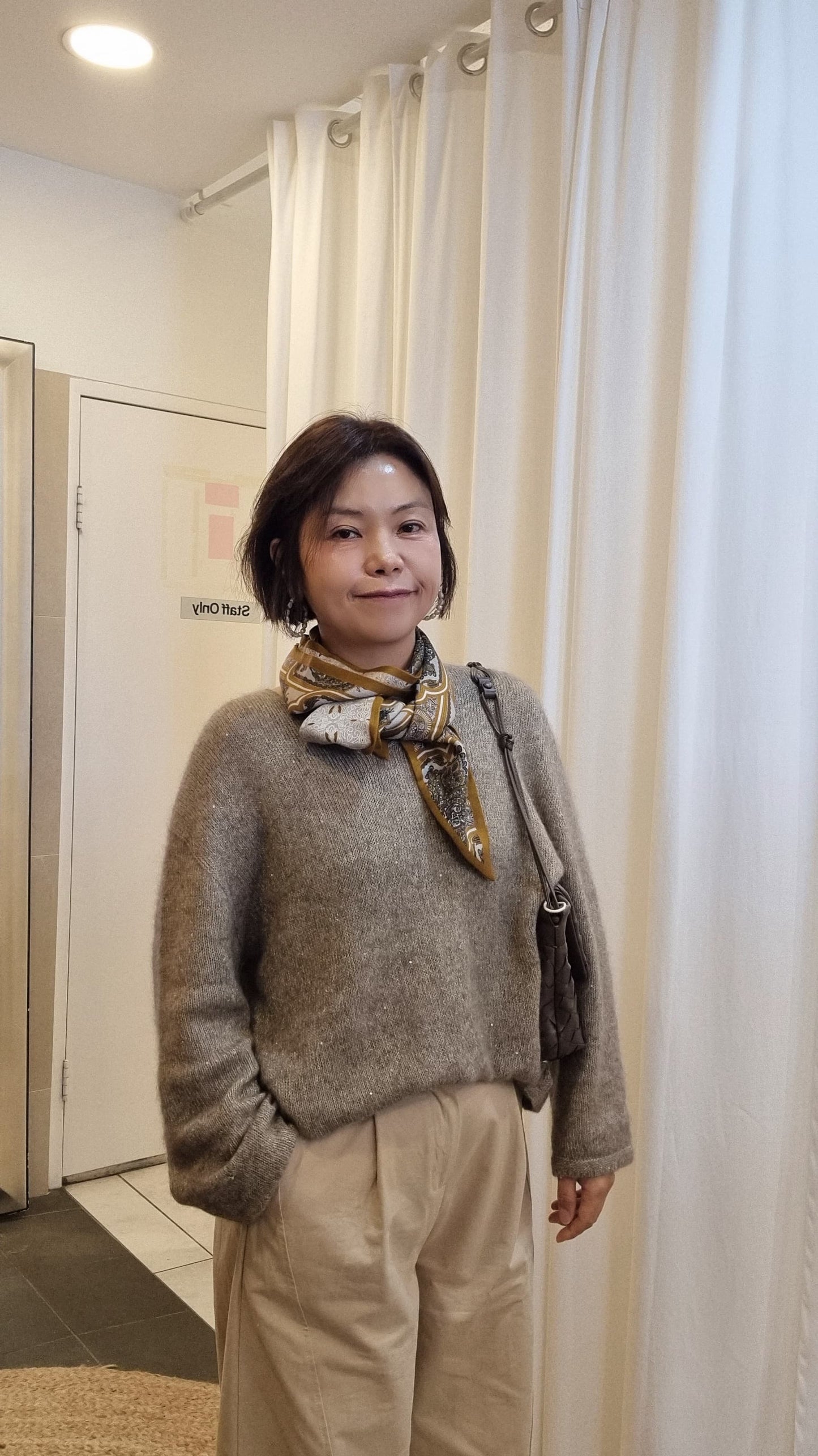 beige knit outfit with patterned silk cashmere scarf front view