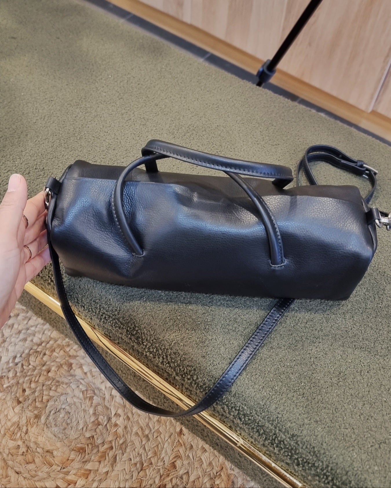 black leather cylinder bag bottom view