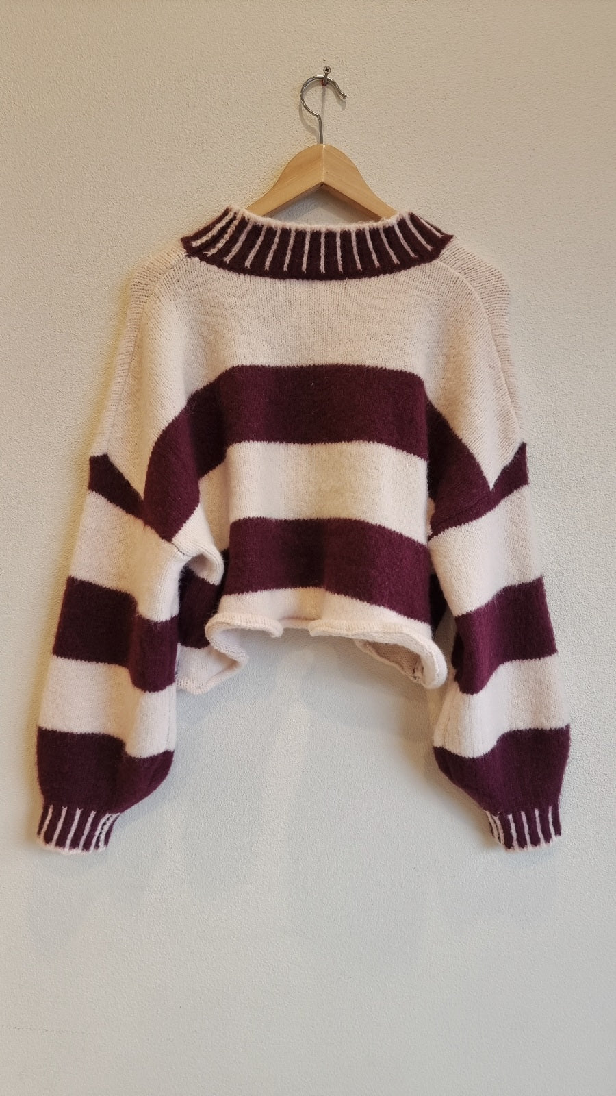 soft stripe knit sweater back view on hanger