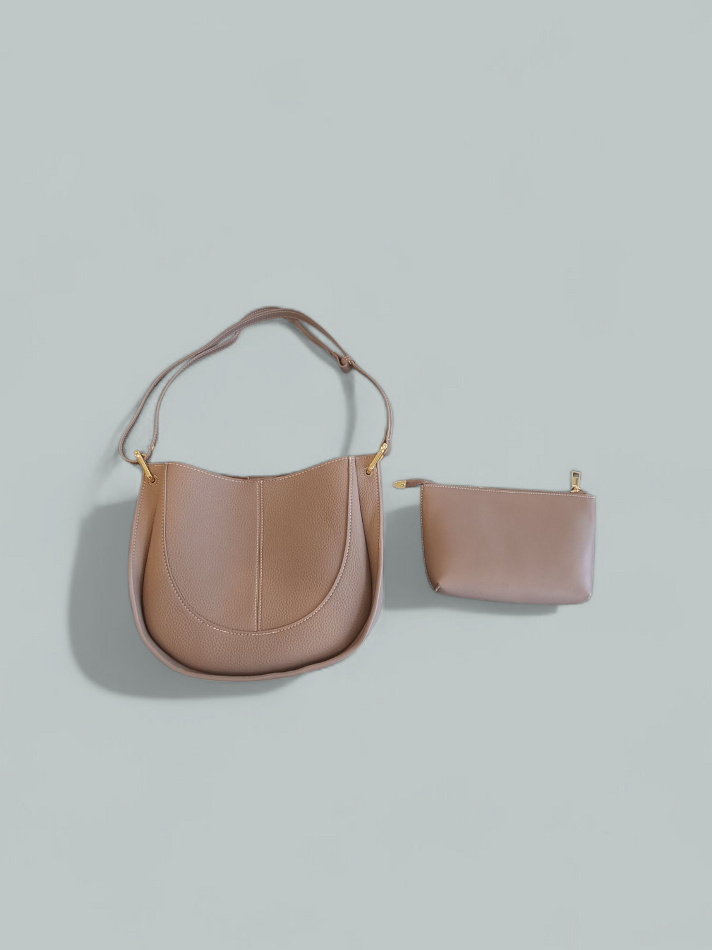 Close-up of the beige leather shoulder bag on a display surface