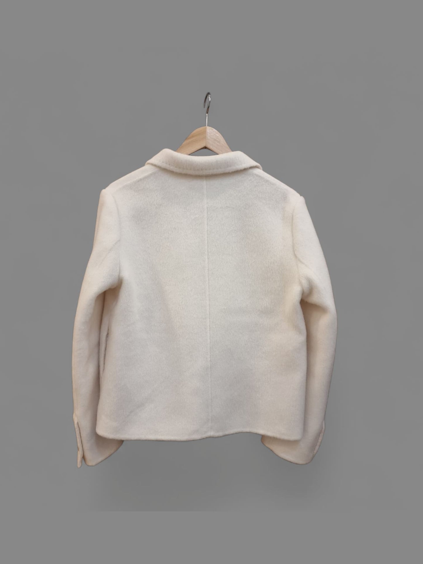 “Back/side view of cream merino wool coat – structured short silhouette by Nova Lux”