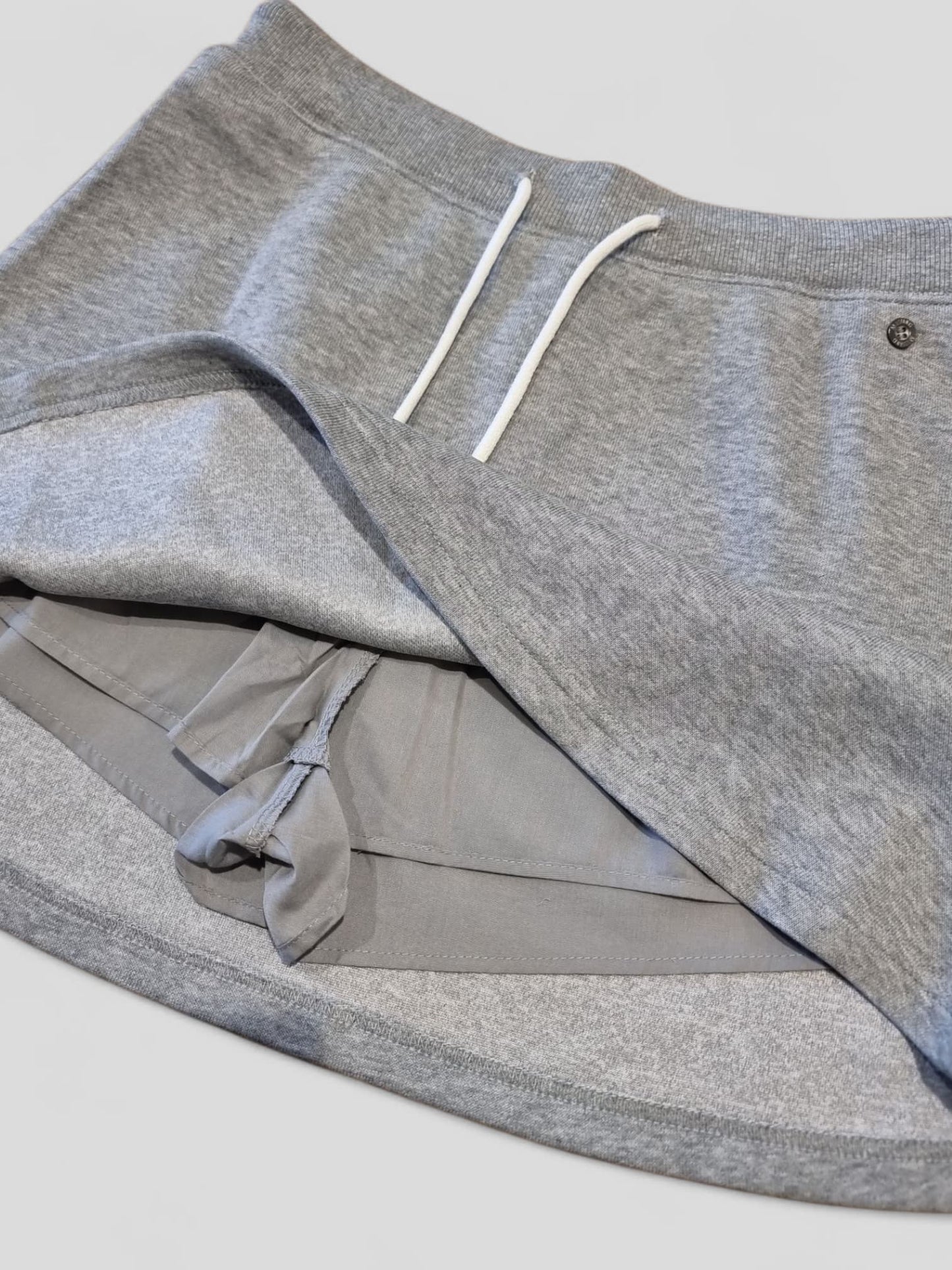 Close-up of the grey MTM skort showing the built-in shorts lining and inner construction, highlighting comfort and coverage details.