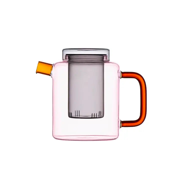 Pink glass Cha Pot with an orange handle and yellow spout on a white background