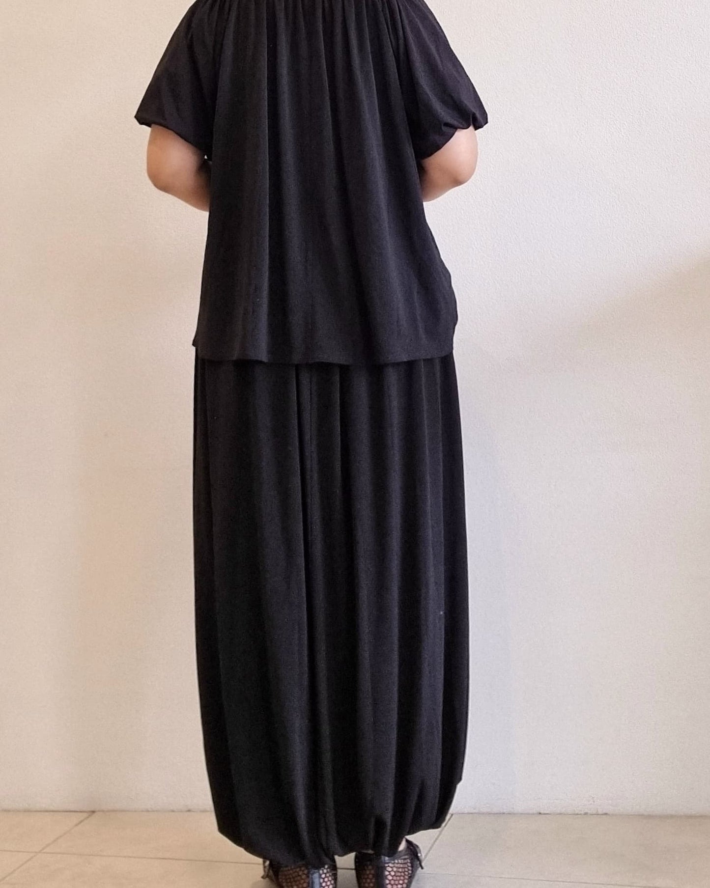 “Back view of the Seren Black Set featuring a relaxed top and balloon-style maxi skirt.”