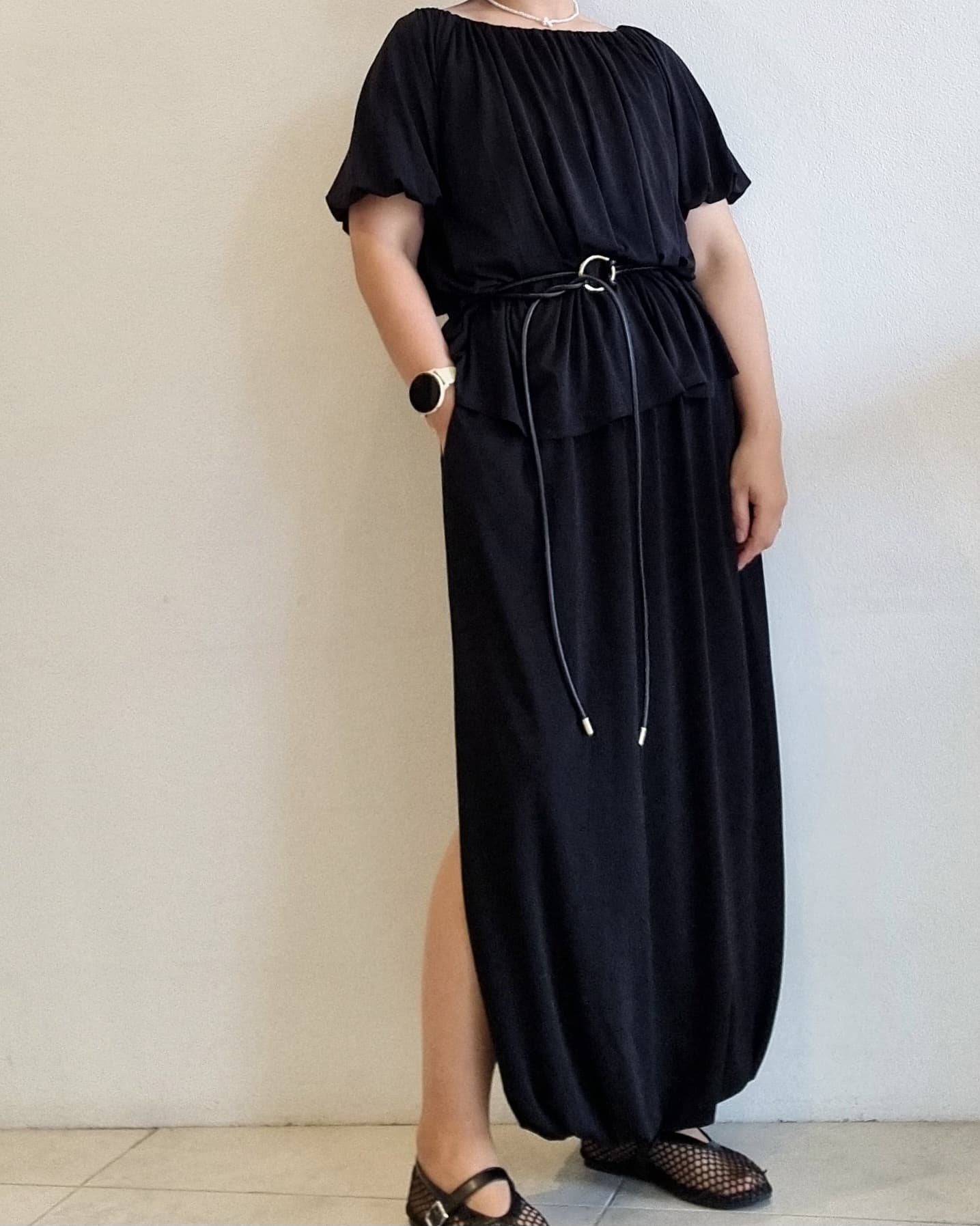 Black two-piece set on model, relaxed fit top and balloon skirt with stretch waist.