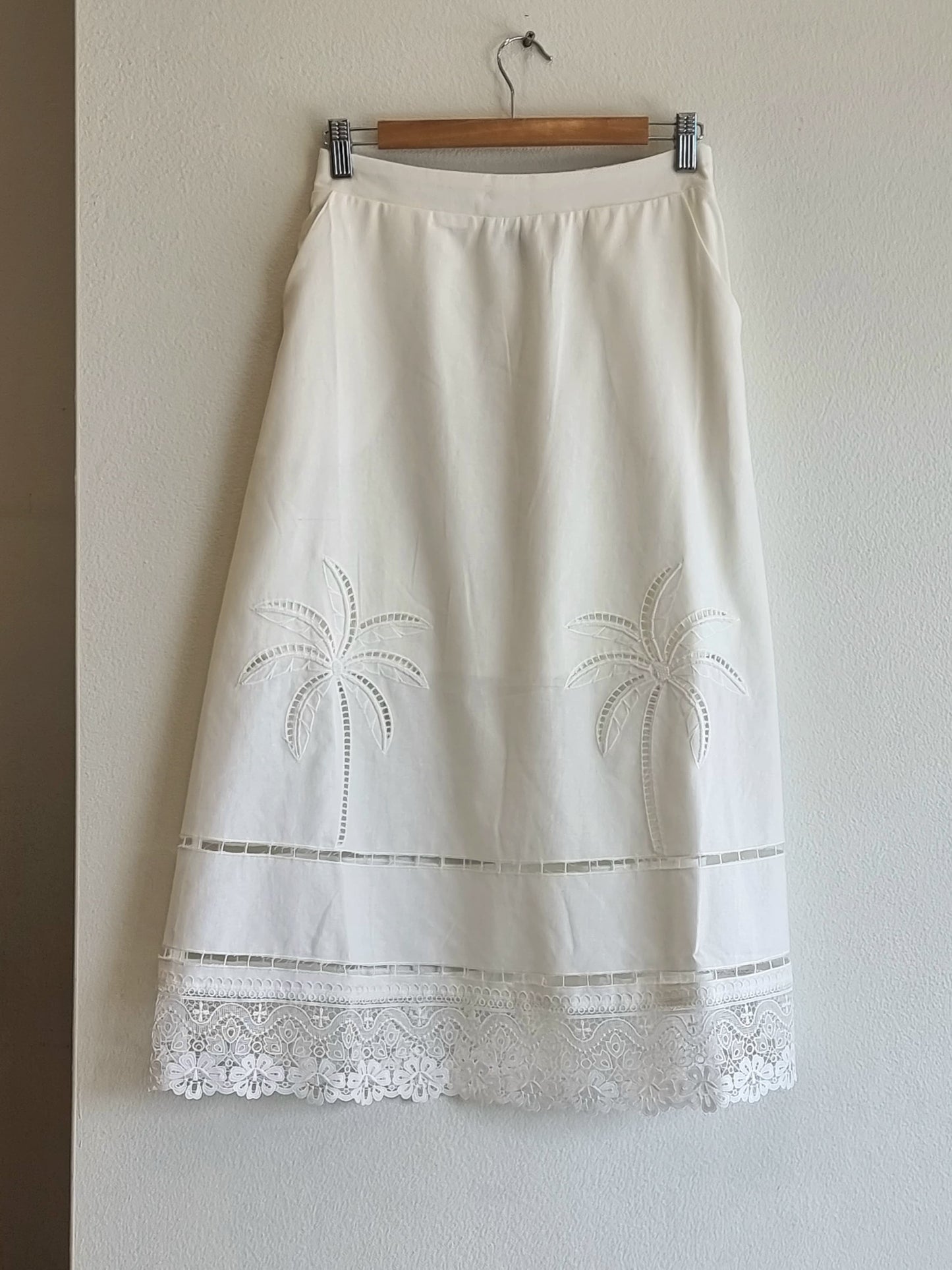 Close-up of palm embroidery detailing on the Palmera Lace Skirt.