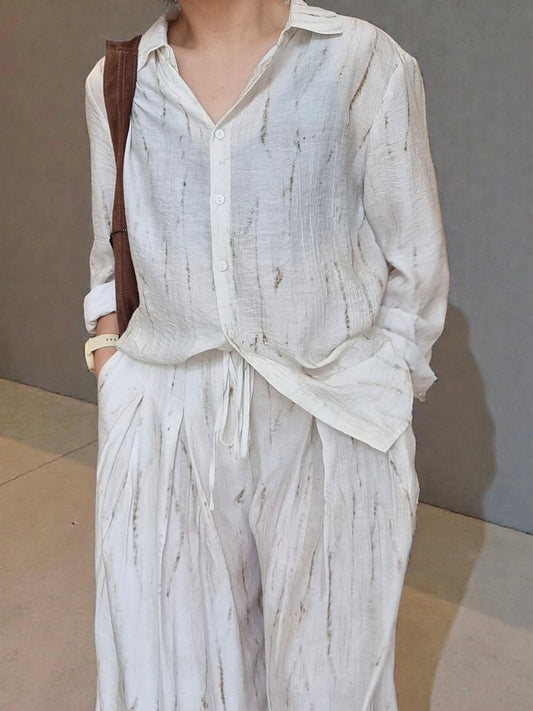 “Oceanus wrinkle-free lightweight shirt and pants set worn by model, natural marble pattern outfit against a neutral wall background – Nova Lux”