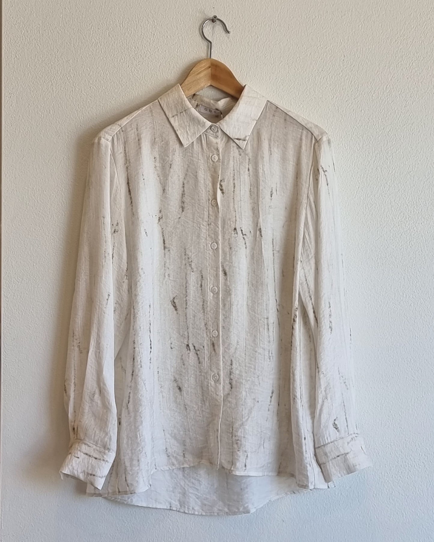 “Full front view of the Oceanus wrinkle-free lightweight marble-pattern shirt hanging on a wooden hanger against a neutral wall – Nova Lux product photo”