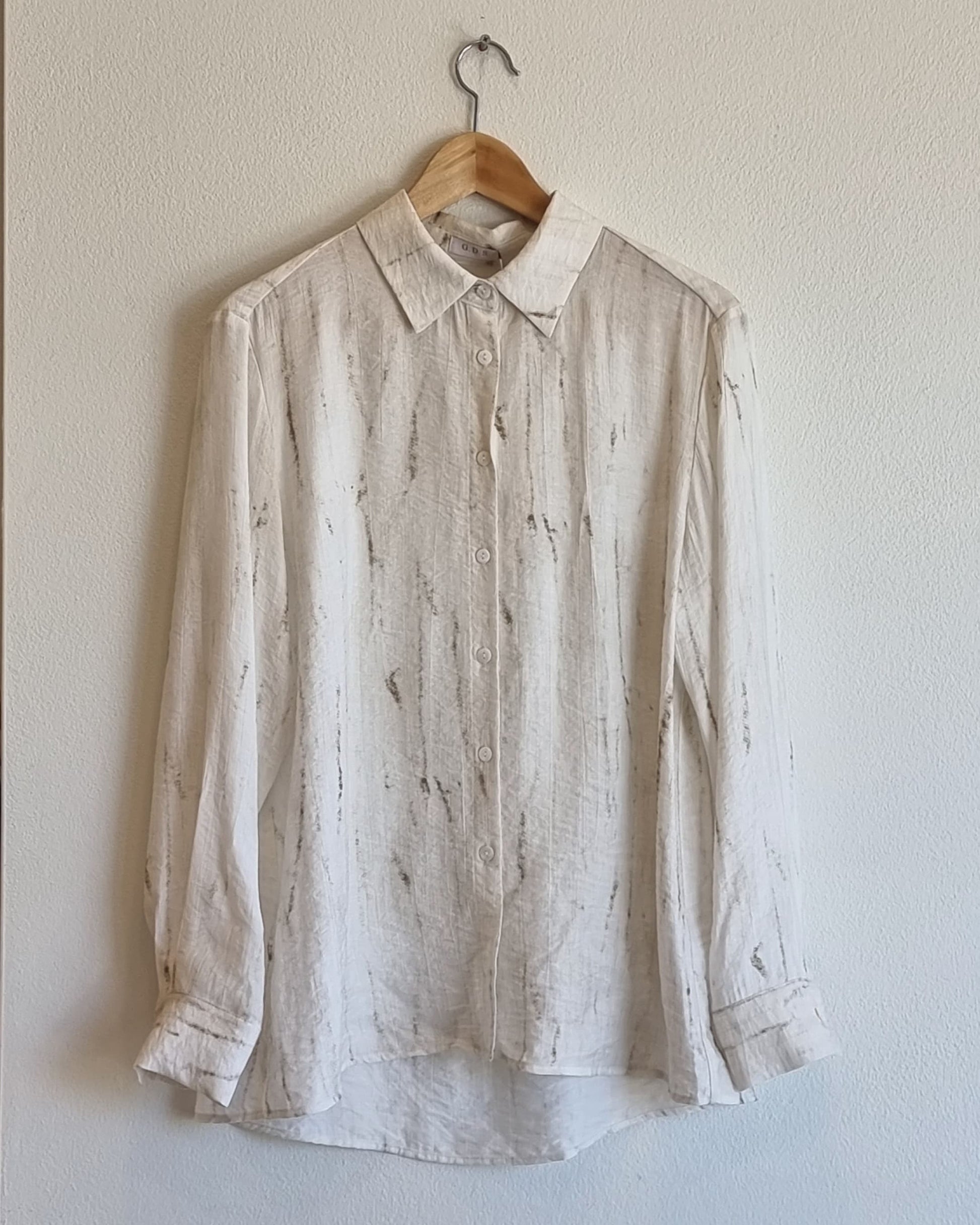 “Full front view of the Oceanus wrinkle-free lightweight marble-pattern shirt hanging on a wooden hanger against a neutral wall – Nova Lux product photo”