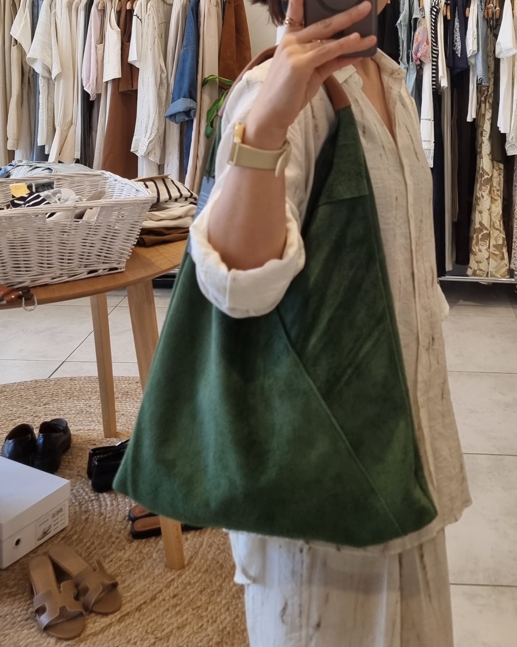 “Green Italian suede shoulder bag with leather handle shown worn in a boutique fitting room for size reference.”