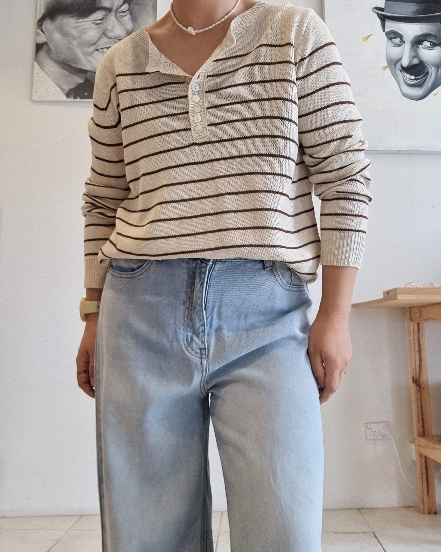 Close-up of beige cotton knit fabric with brown stripe detailing.