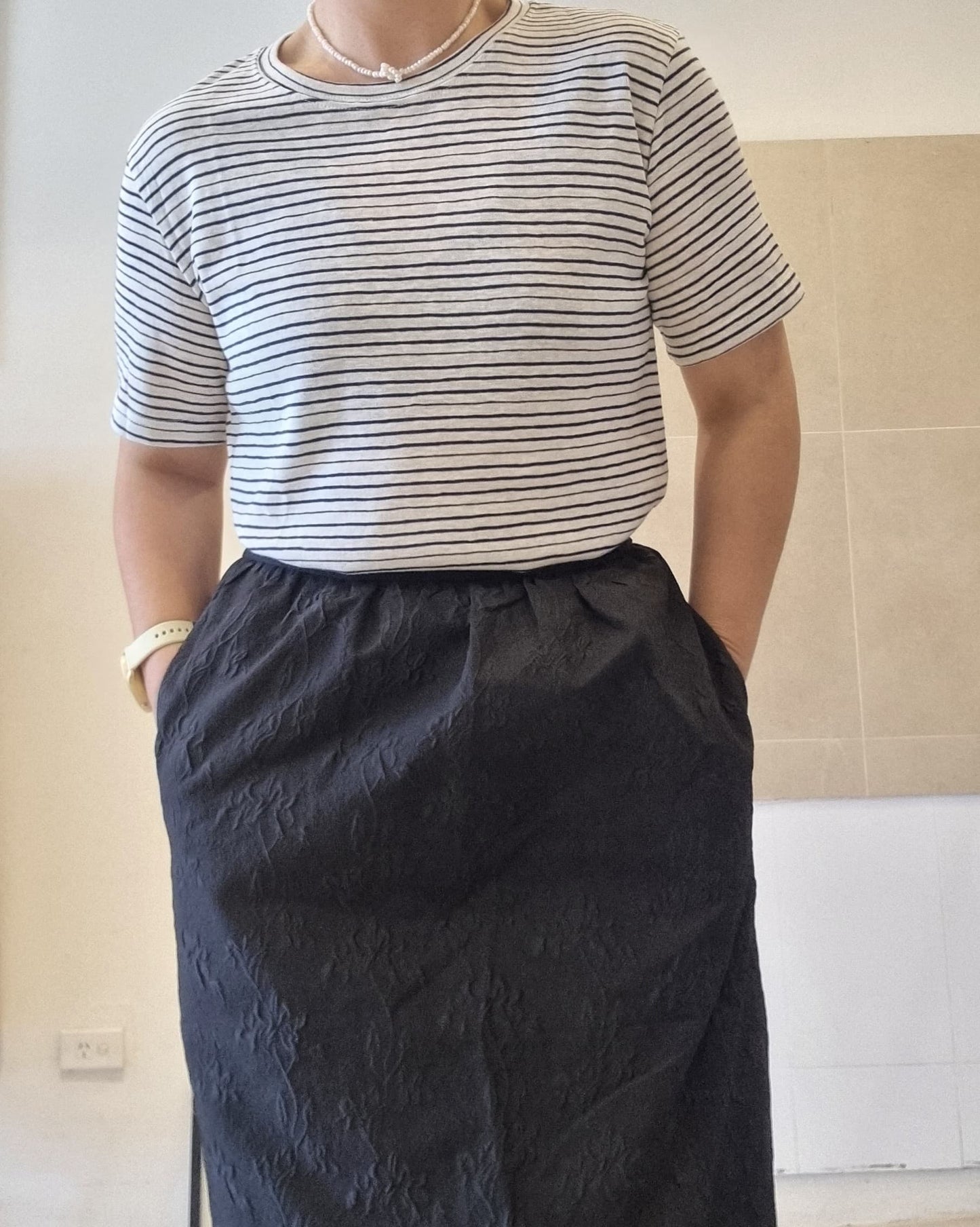 Black stripe cotton linen t-shirt worn with long black skirt, relaxed fit styling