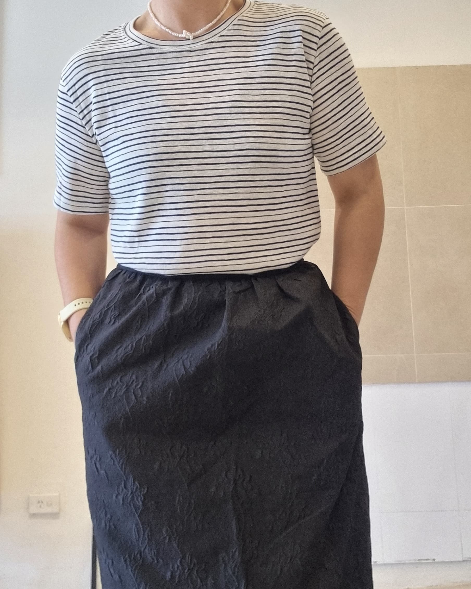 Black stripe cotton linen t-shirt worn with long black skirt, relaxed fit styling