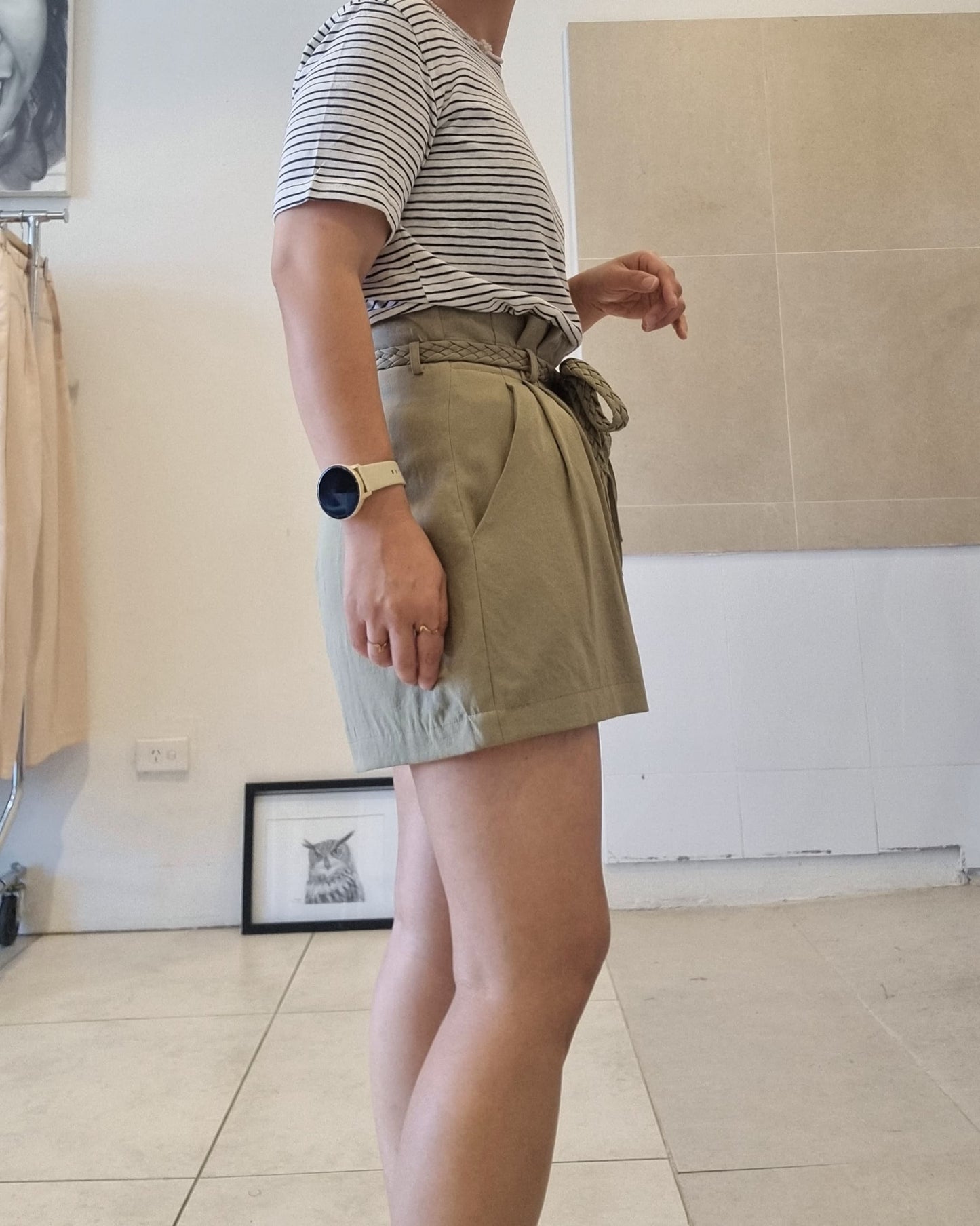 Side view of black stripe cotton linen t-shirt styled with khaki shorts, relaxed summer fit