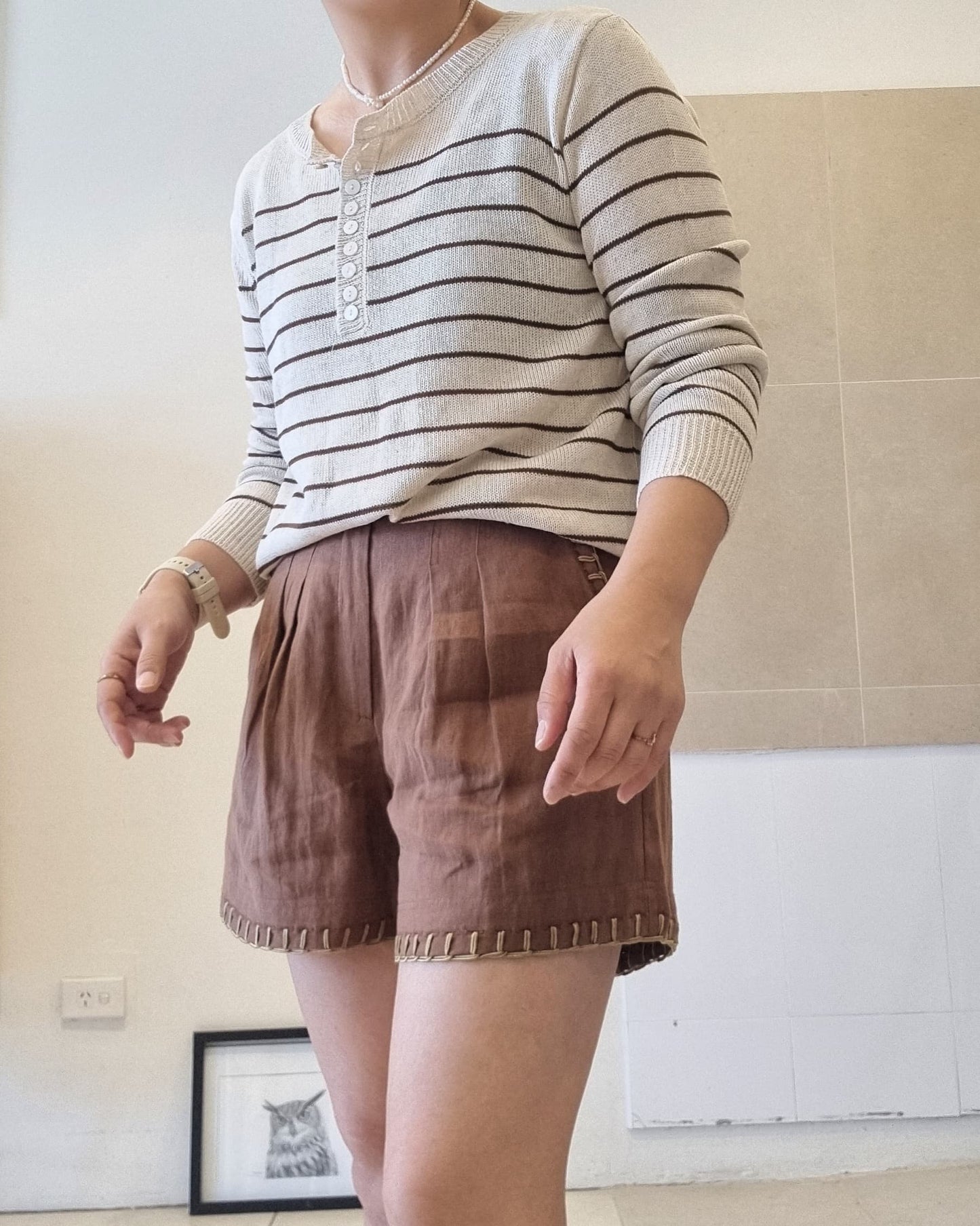 Women’s striped cotton linen henley top, relaxed fit, paired with brown shorts