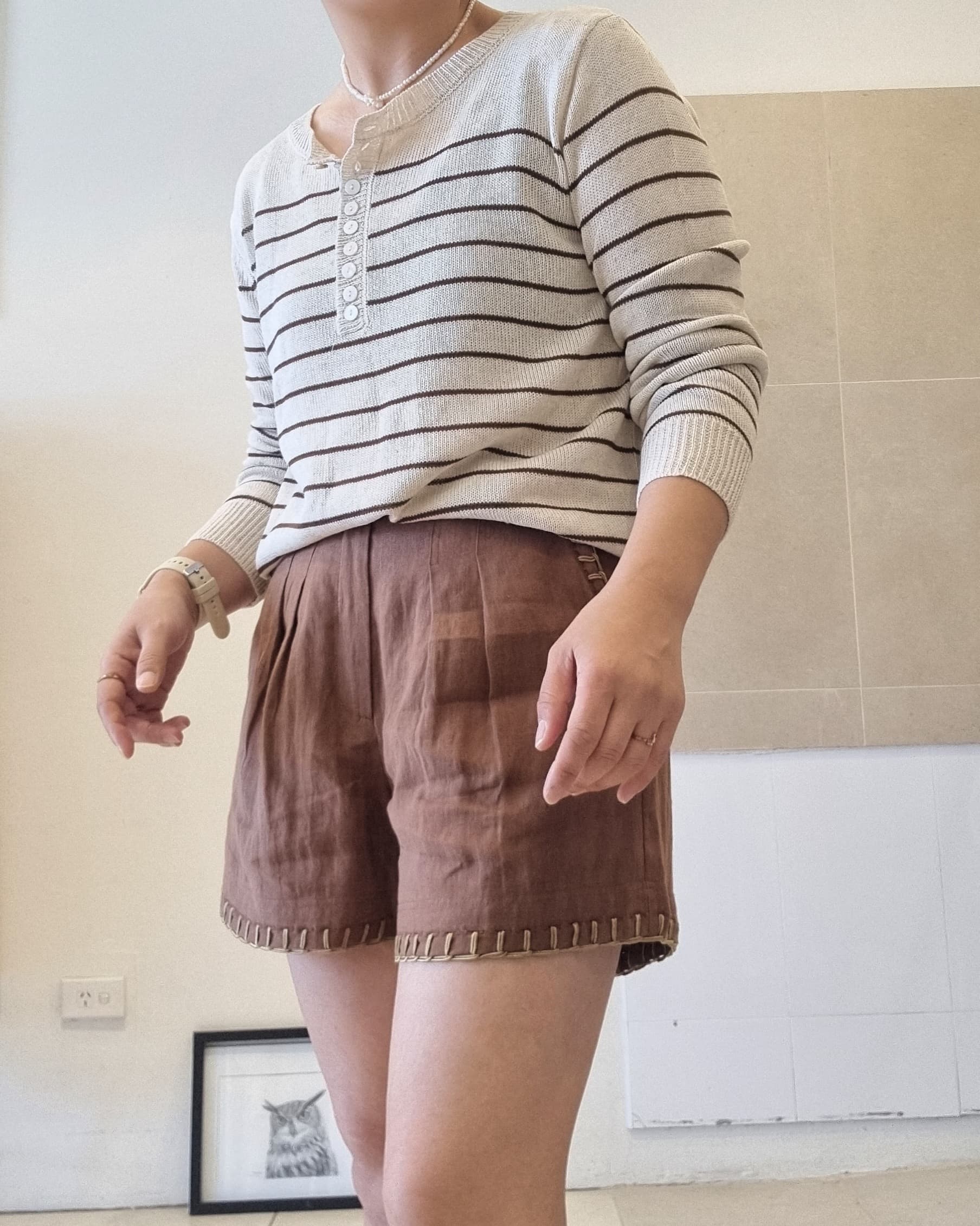 Women’s striped cotton linen henley top, relaxed fit, paired with brown shorts