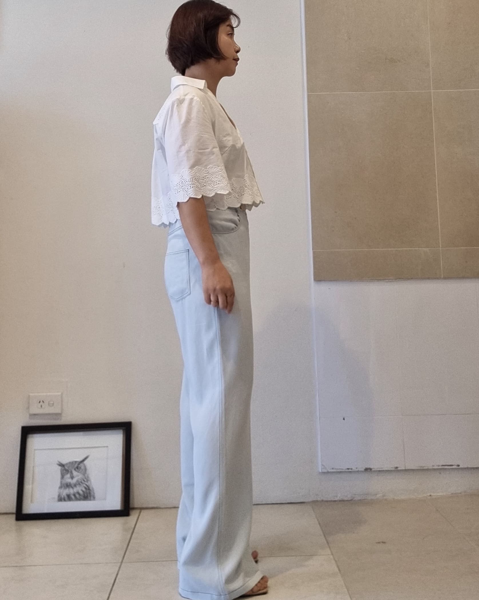 Light blue Tencel wide-leg pants with straight silhouette, side view showing soft drape