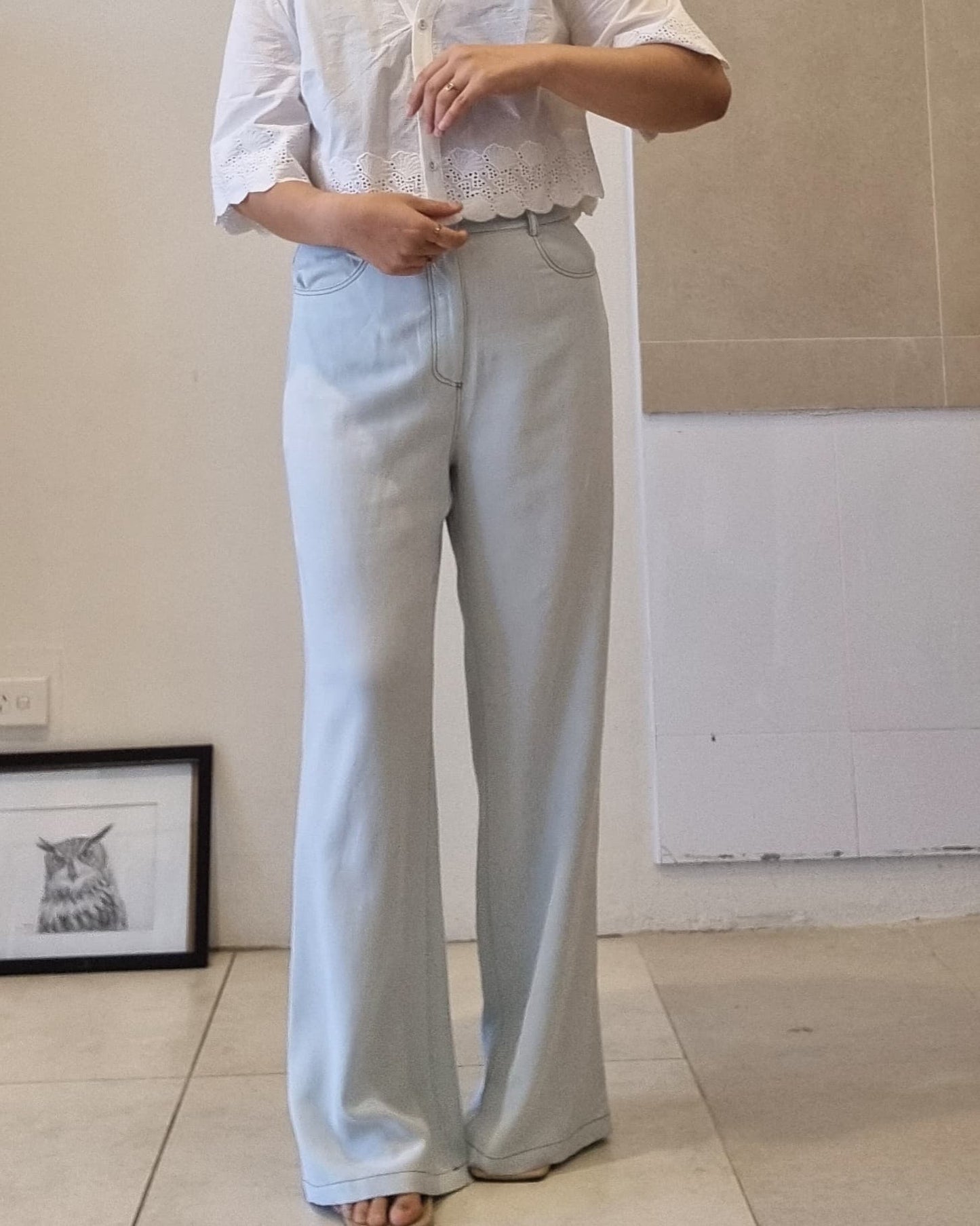 Light blue Tencel wide-leg pants with soft drape and high-waist fit, front view