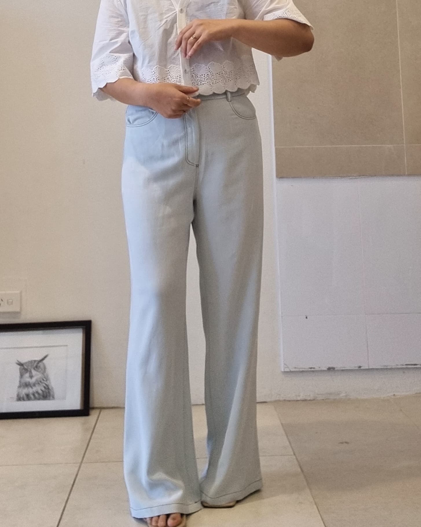 Light blue Tencel wide-leg pants with soft drape and high-waist fit, front view