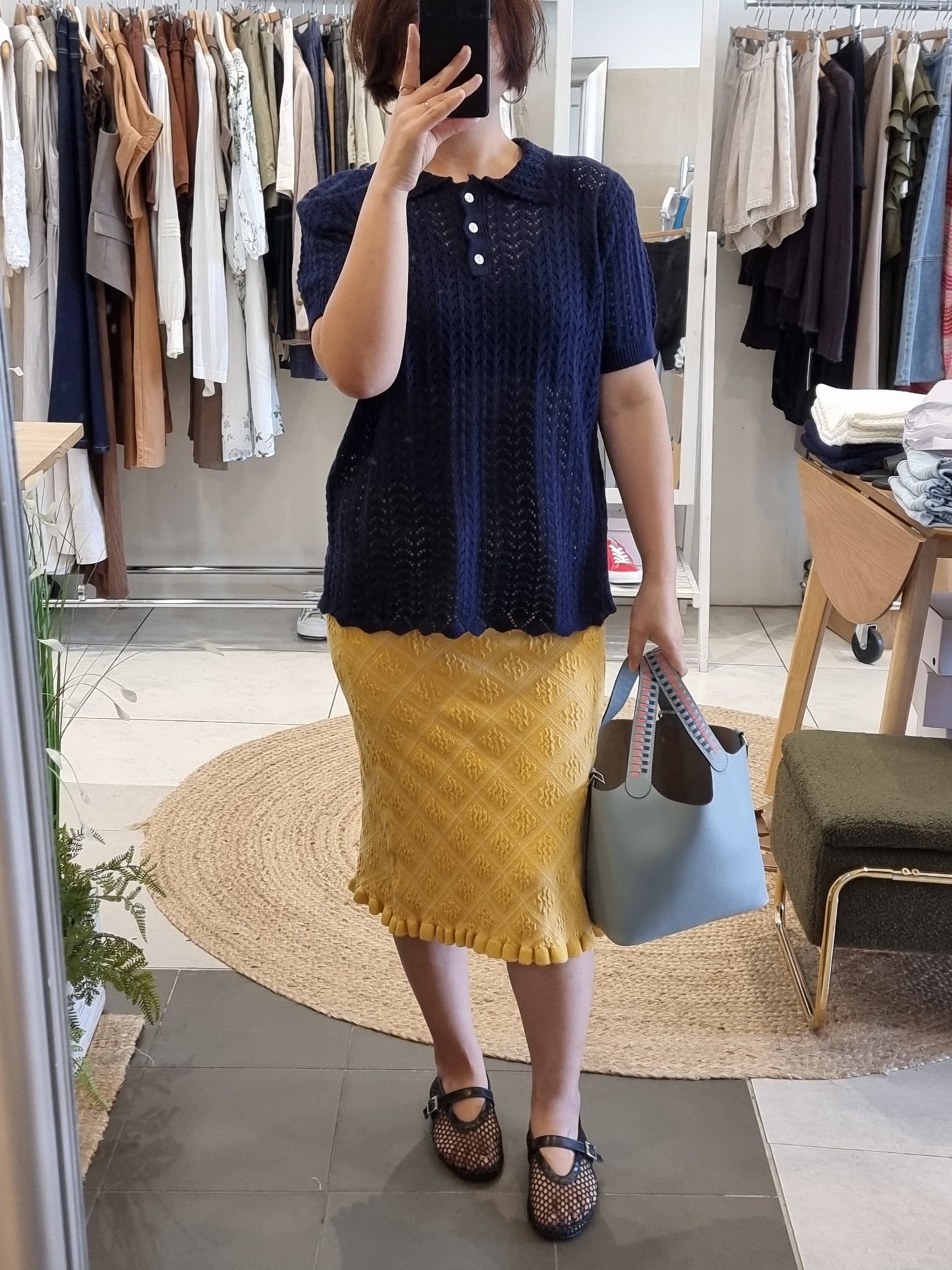 Model wearing navy lace collar knit top with soft feminine fit