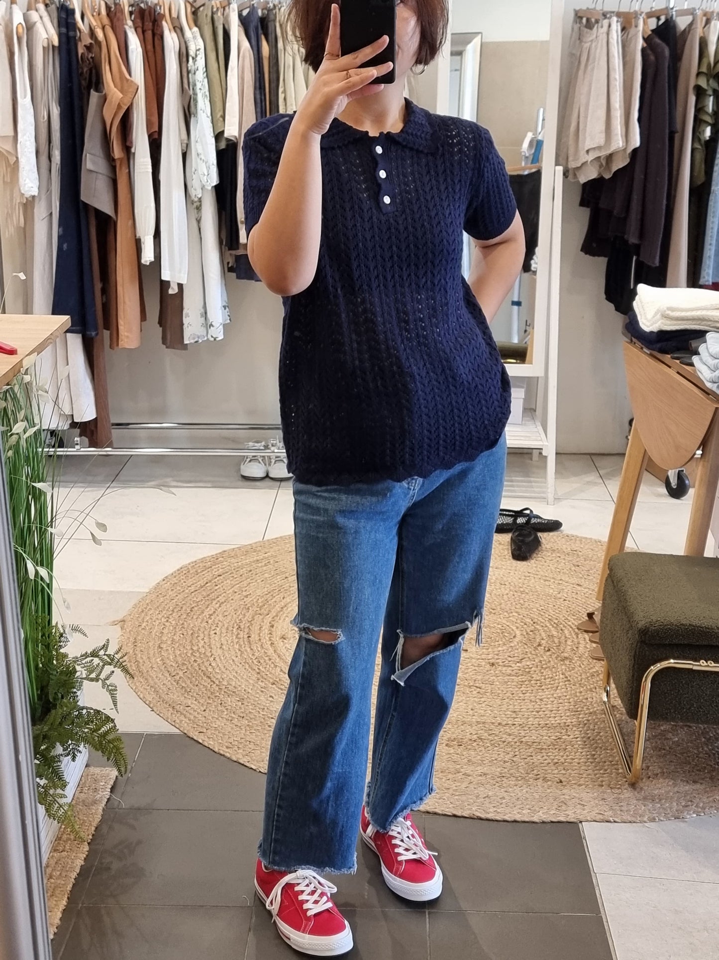 Navy lace knit top styled on model for everyday wear