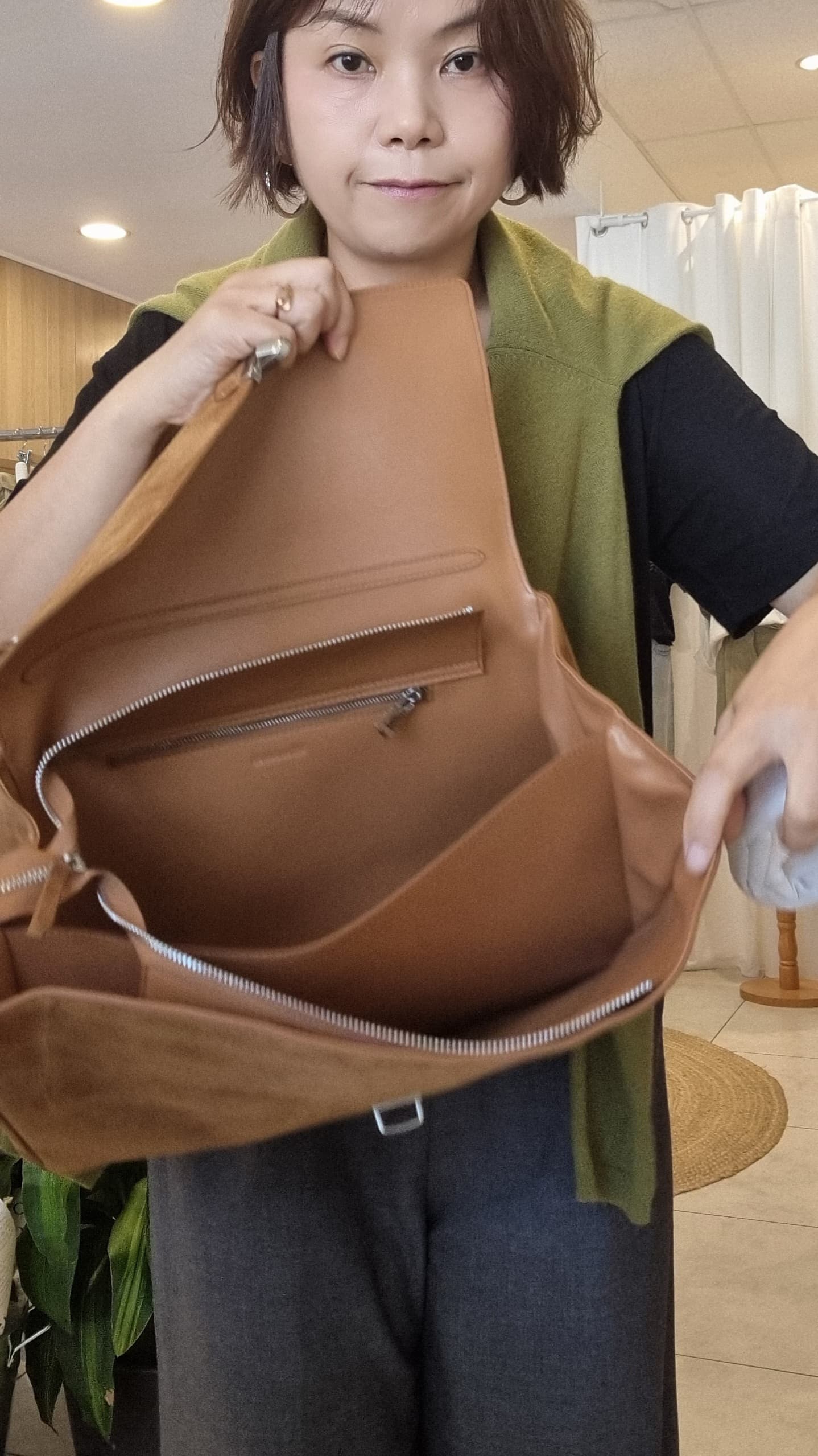 Model showing inside of camel suede leather bag