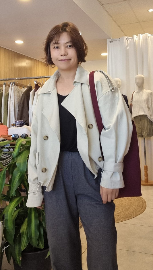 Model wearing the Cream Breeze Short Trench, front view