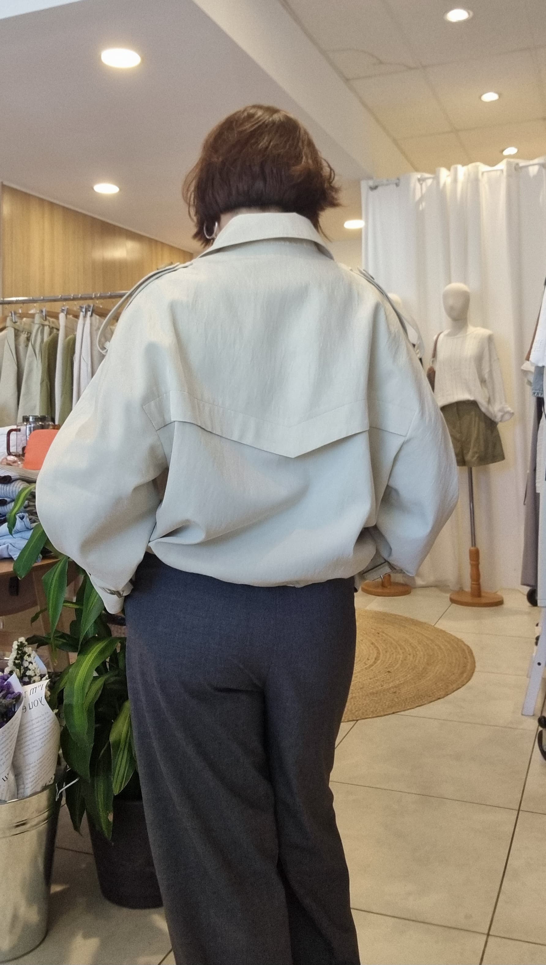 Cream short trench coat, back view with lining structure