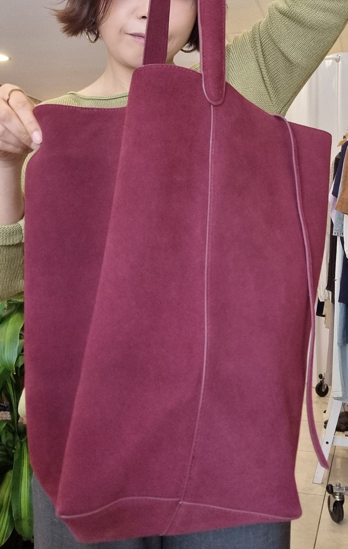 Burgundy suede tote bag styled with knitwear, lifestyle look