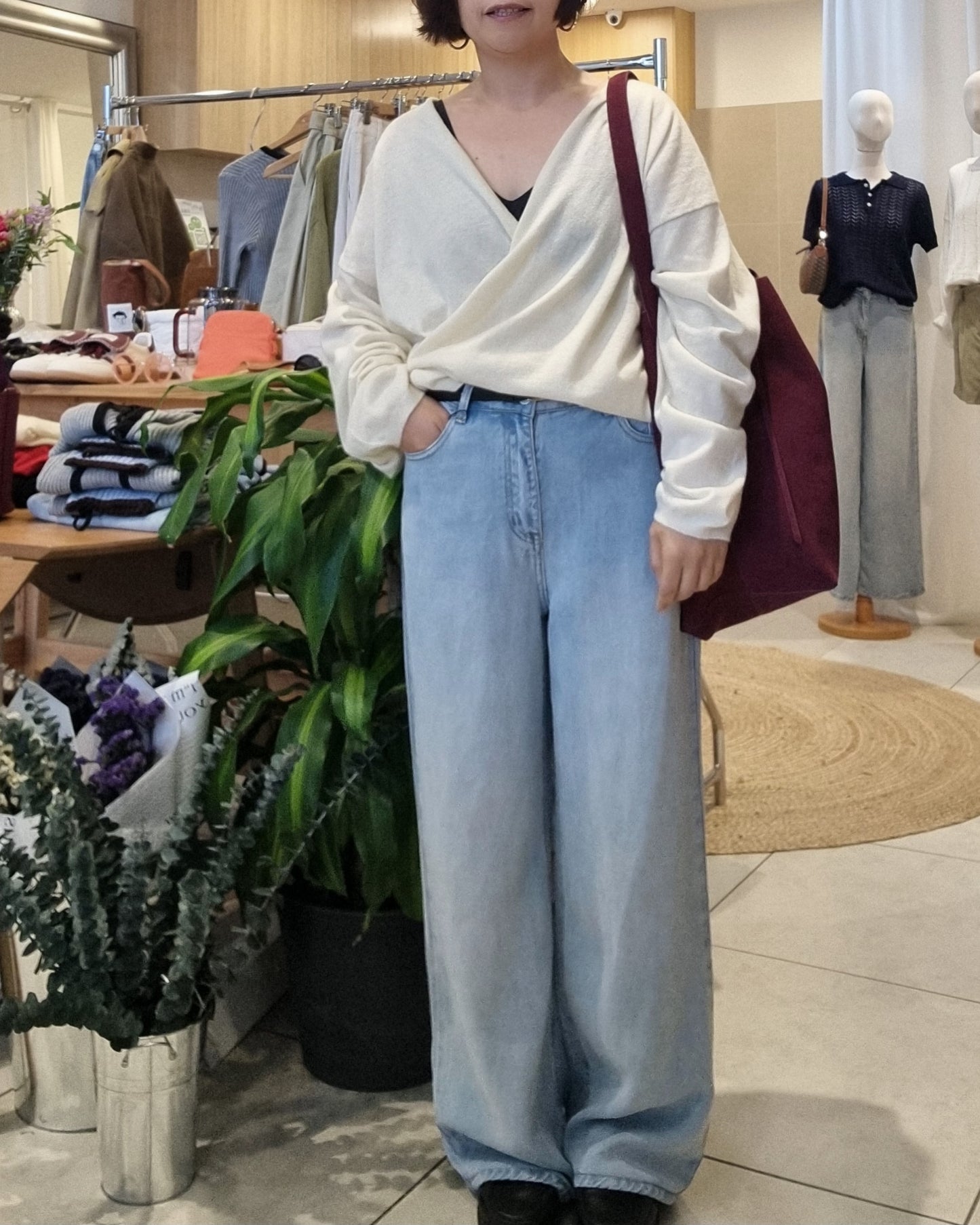 Front view of model wearing cream wrap knit with V-neck detail