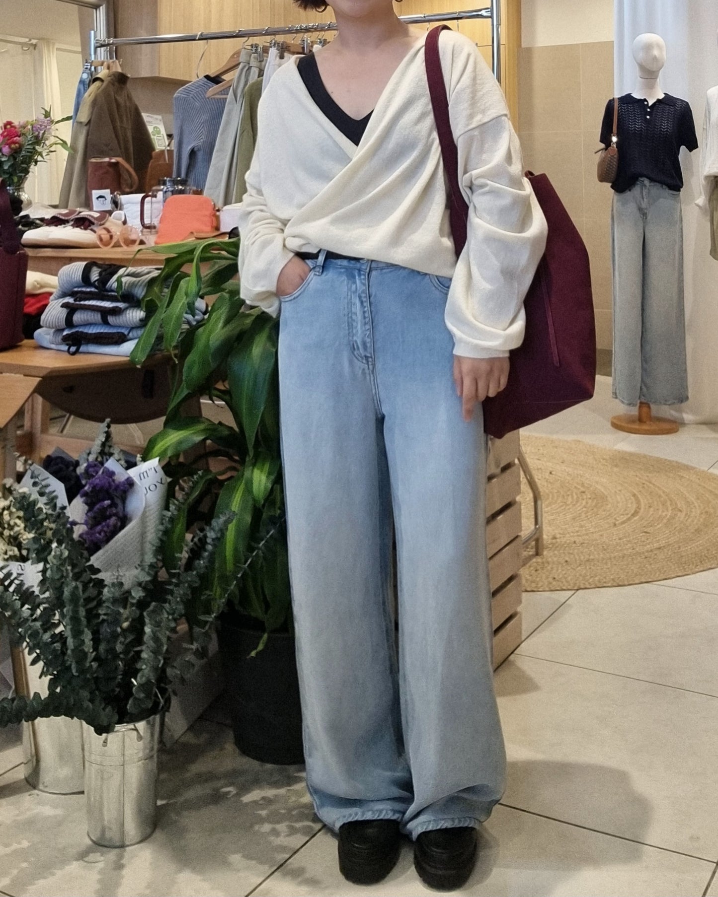 Model wearing cream wrap knit, front view, relaxed fit styling