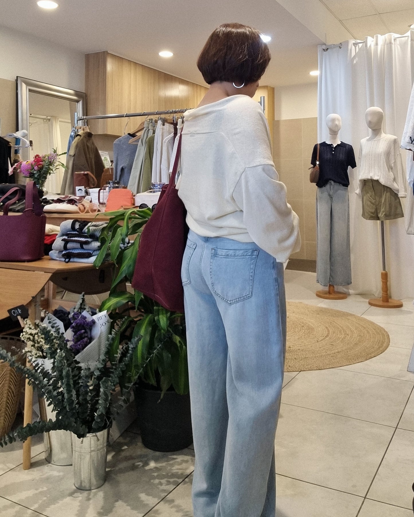 Back view of model wearing cream wrap knit, relaxed casual fit