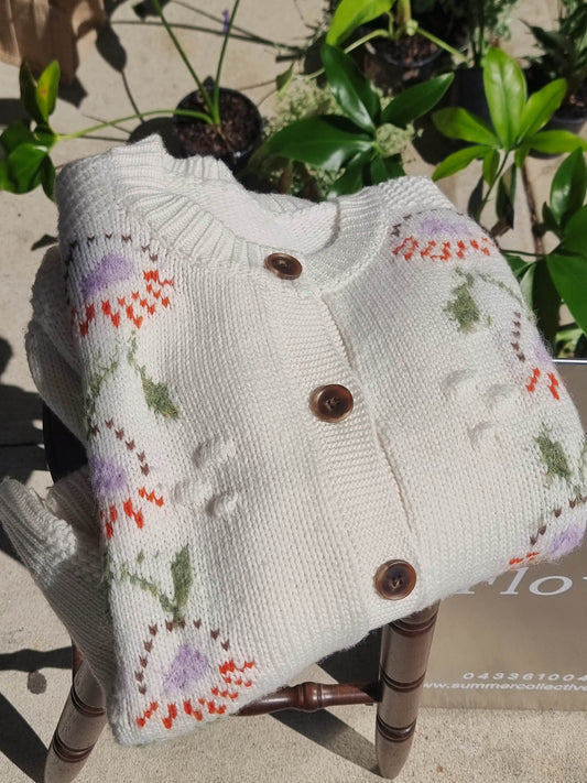 Cream floral wool cardigan placed on chair