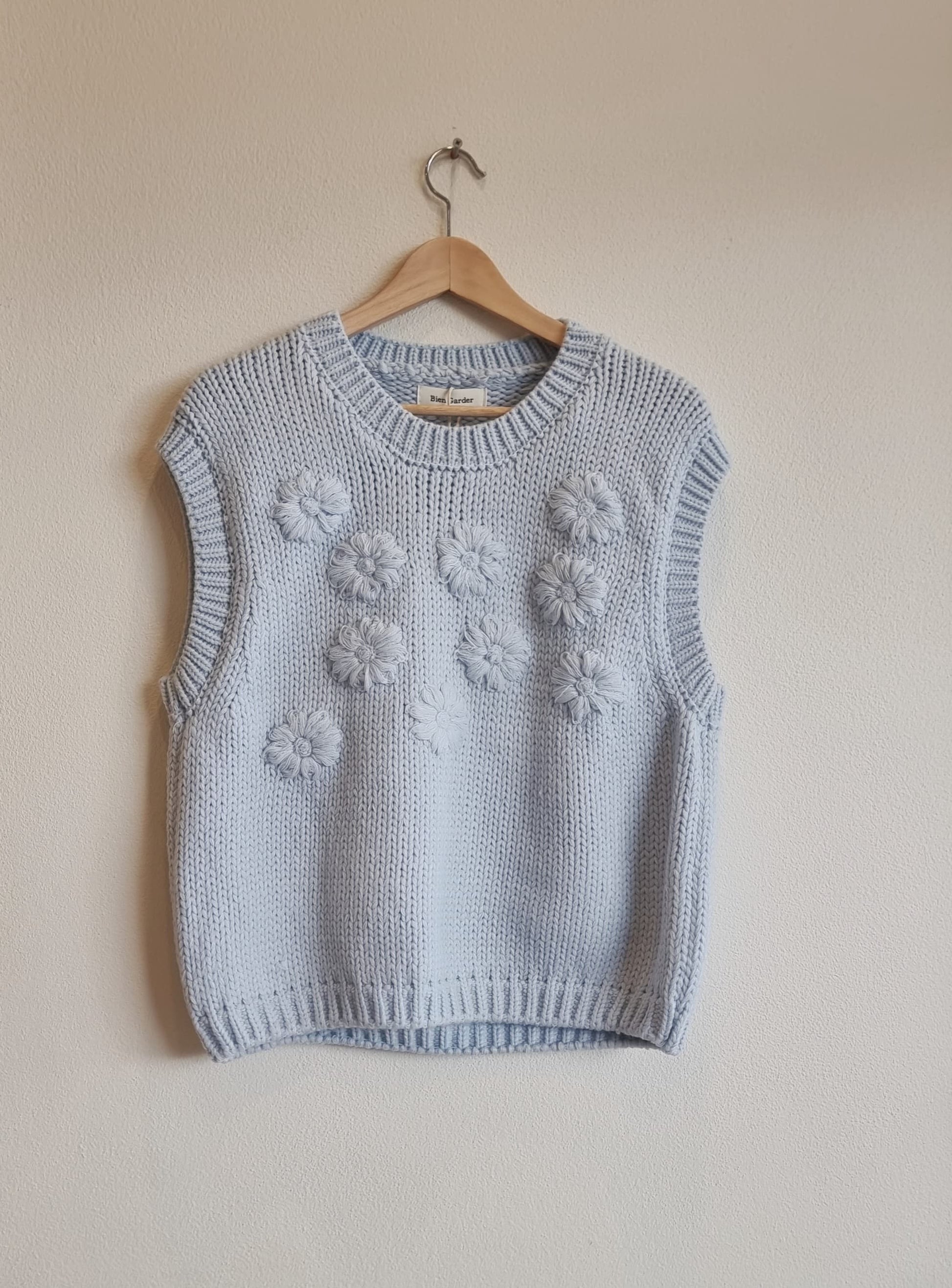 Blue daisy flower knit vest on hanger