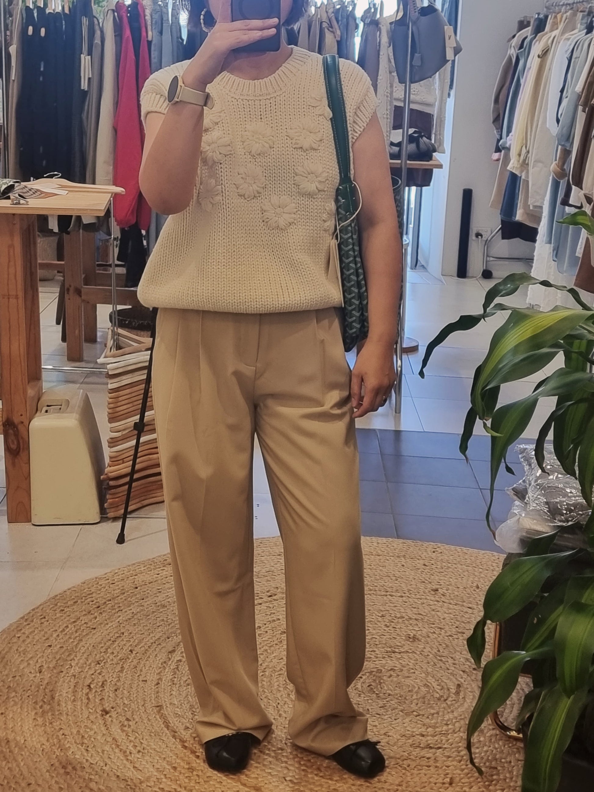 Model wearing cream daisy flower knit vest casual outfit