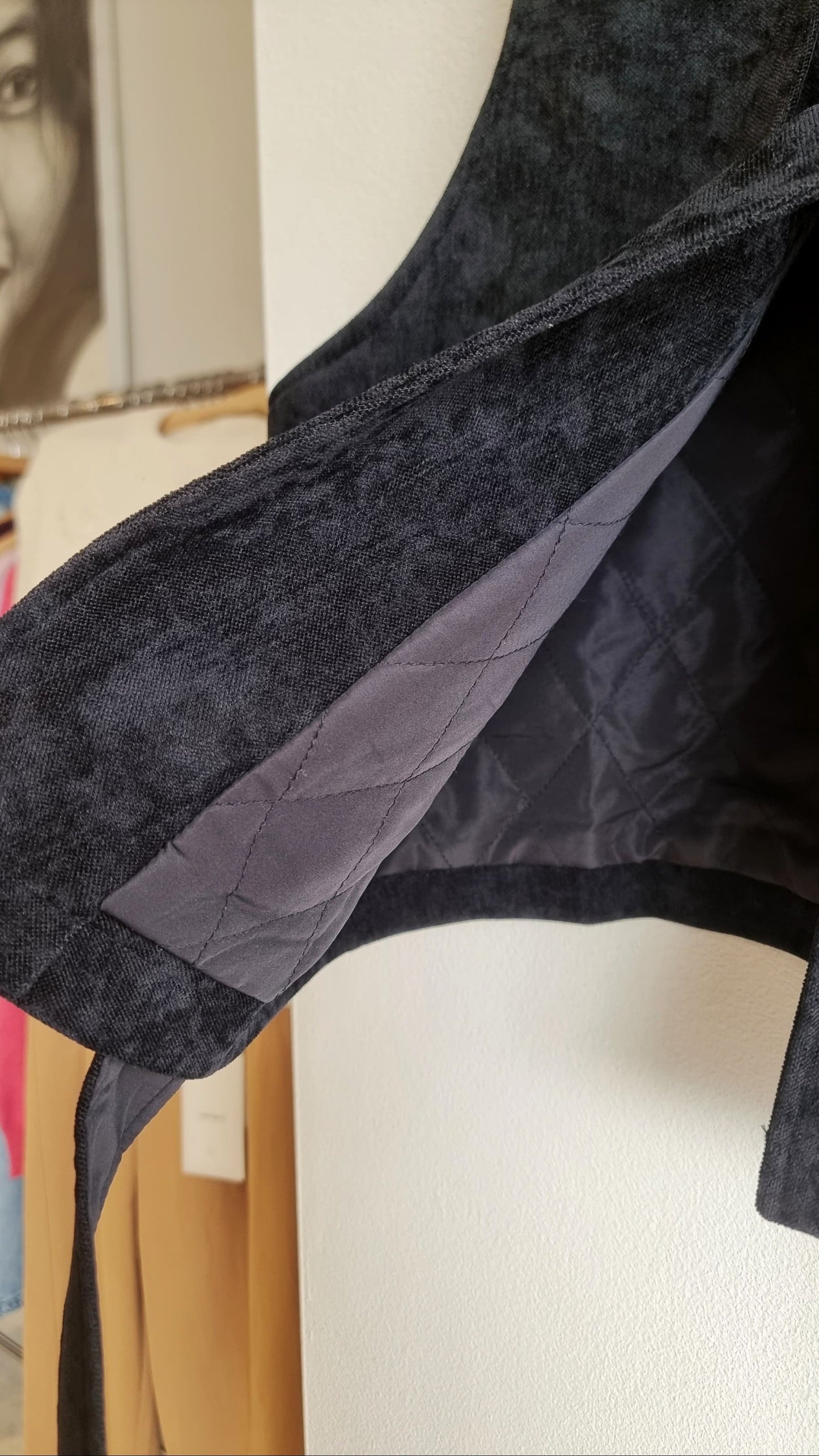 Close-up of black corduroy fabric with inner lining detail