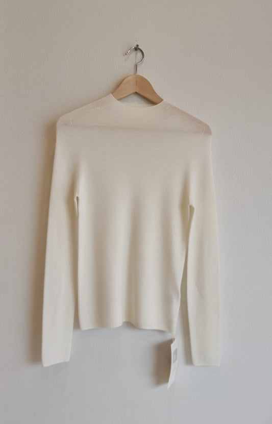 Cream wool sweater on hanger