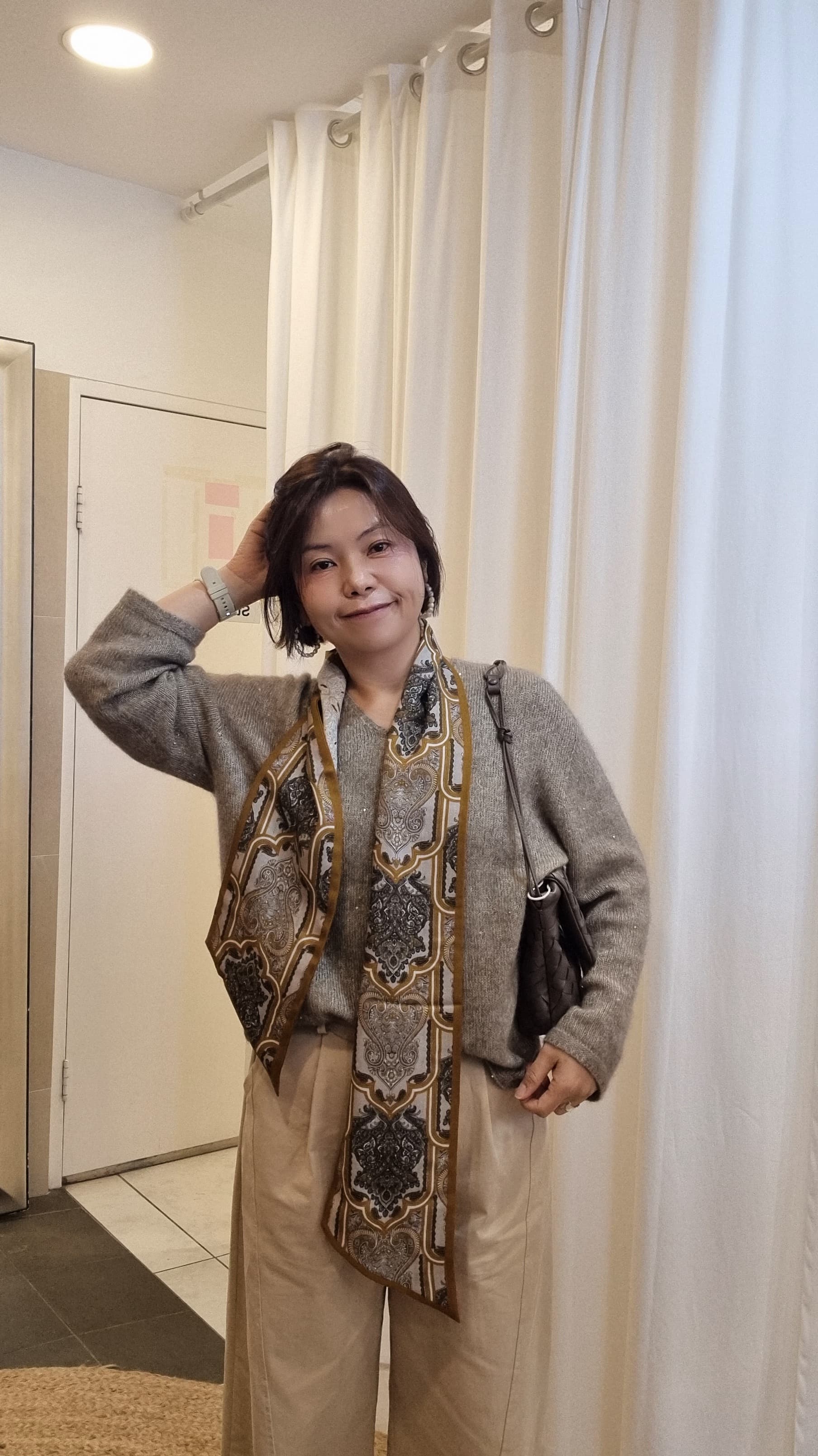 woman styling cashmere silk scarf with beige knit outfit
