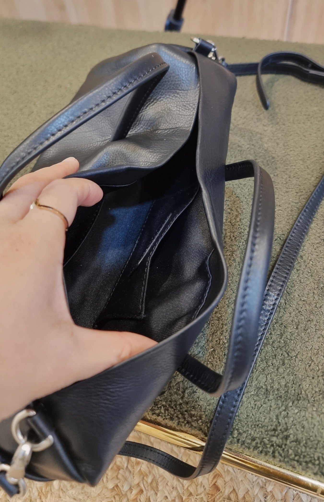 black leather cylinder bag strap detail close up