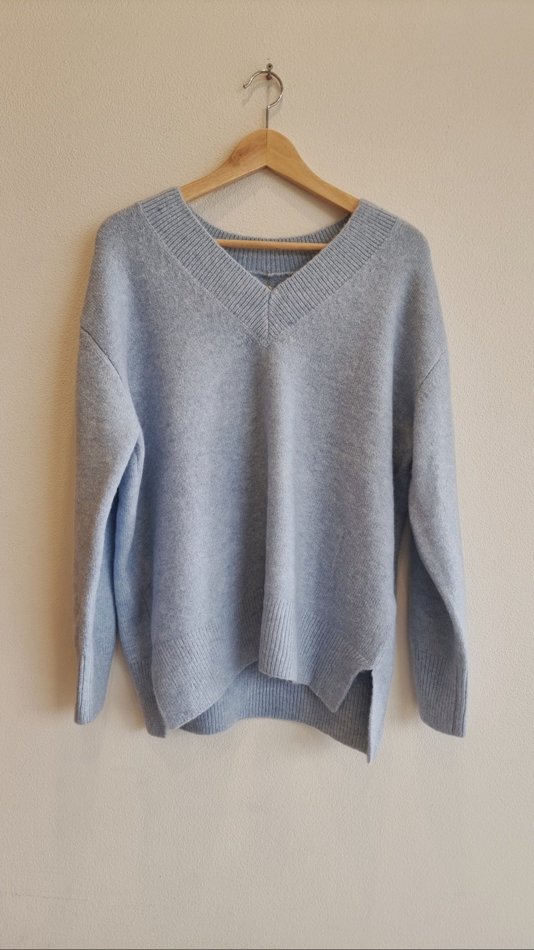 Light blue wool blend V-neck sweater with relaxed fit silhouette