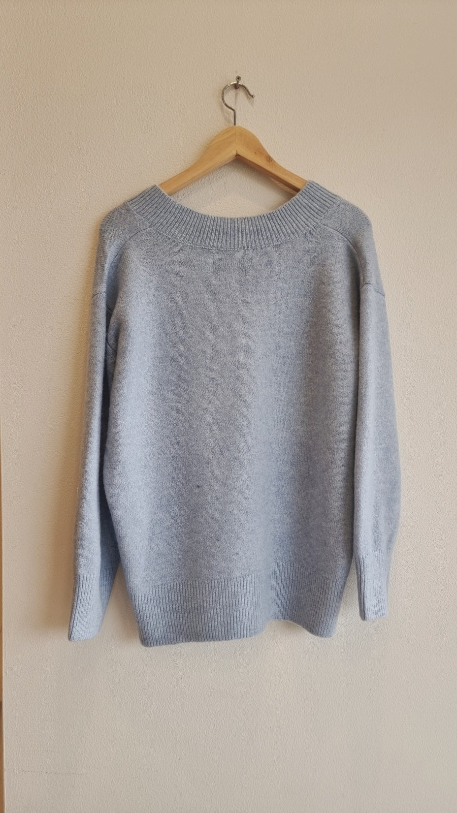Soft blue knit sweater with side slit detail and high-low hem
