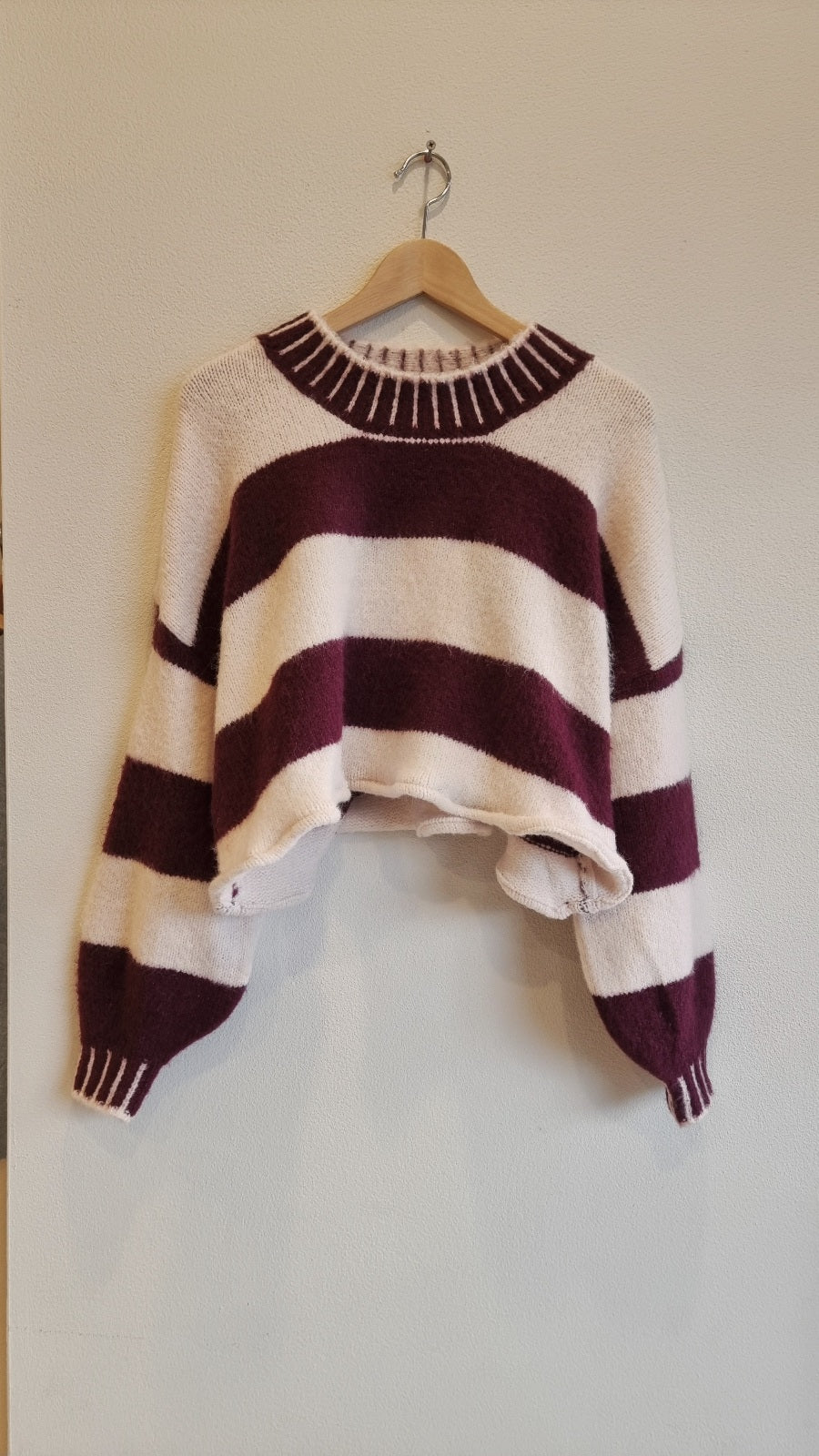 soft stripe knit sweater front view on hanger