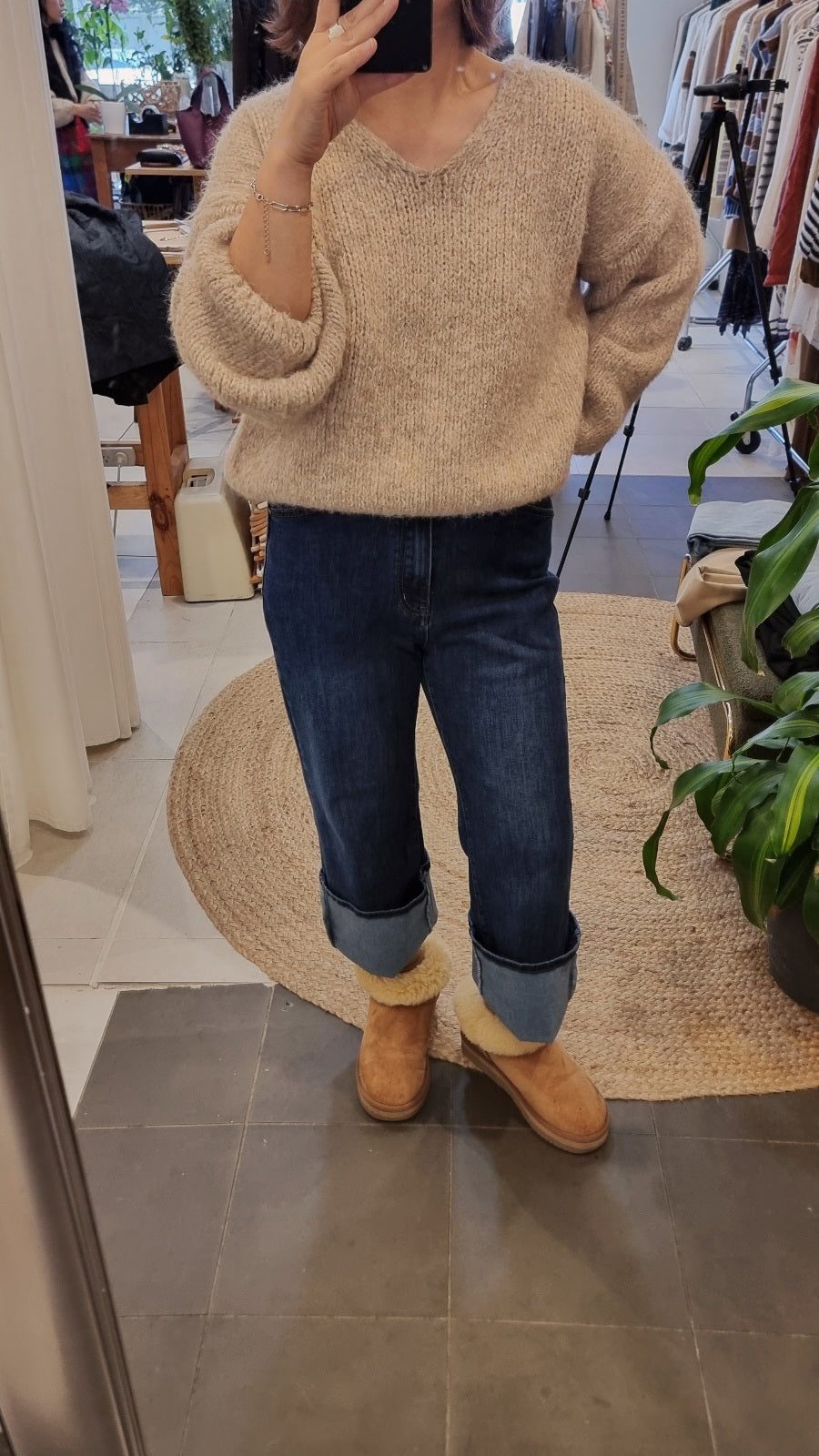 Beige soft wool blend knit sweater with relaxed fit styled with denim jeans