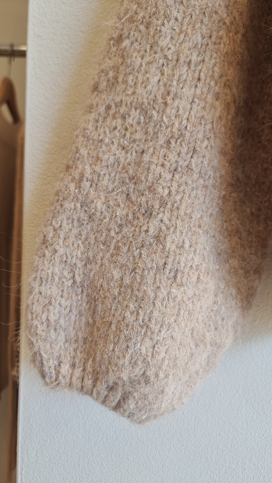 Close-up texture of beige wool blend knit sweater