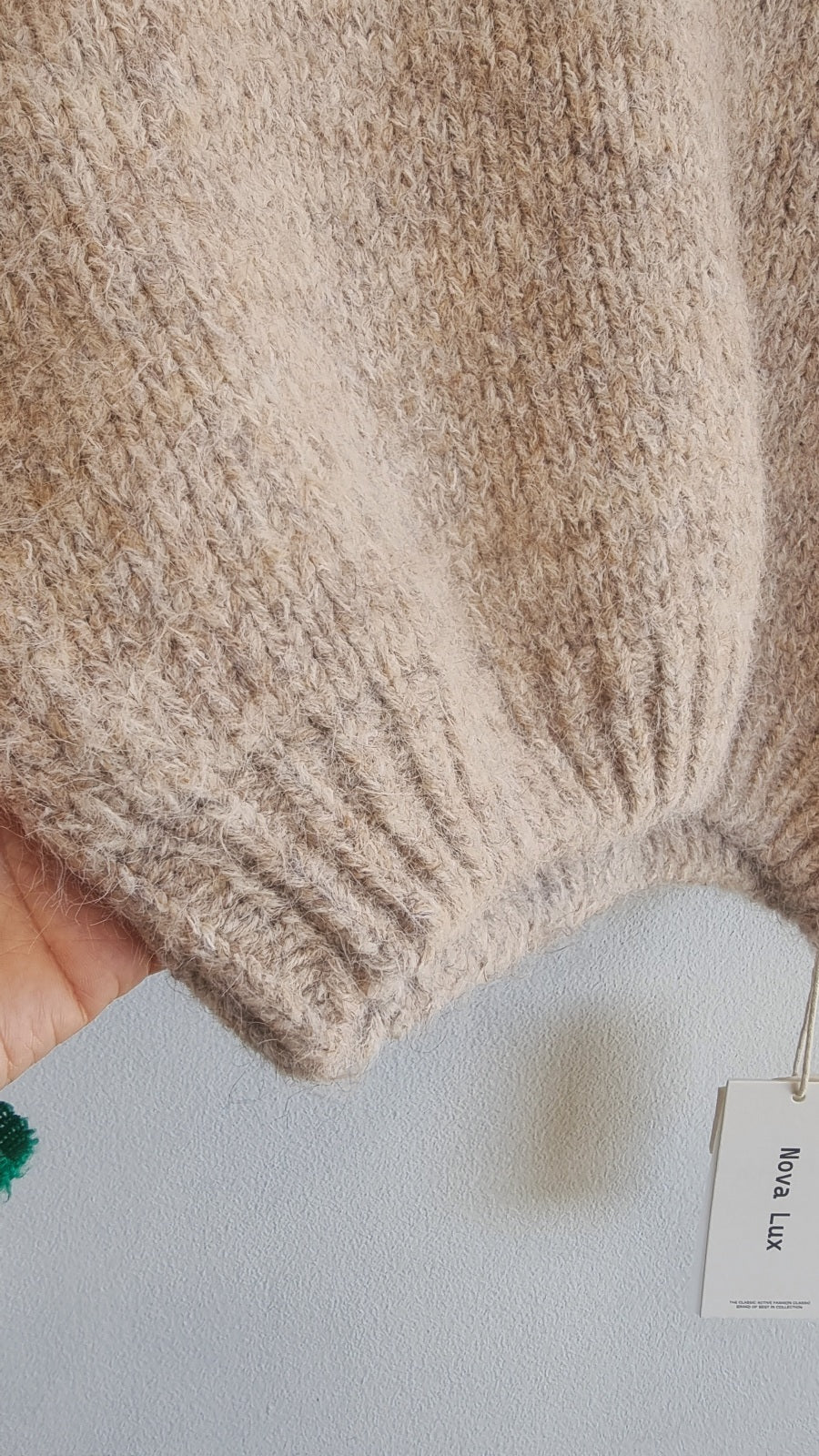 Close-up texture of soft beige wool blend knit sweater