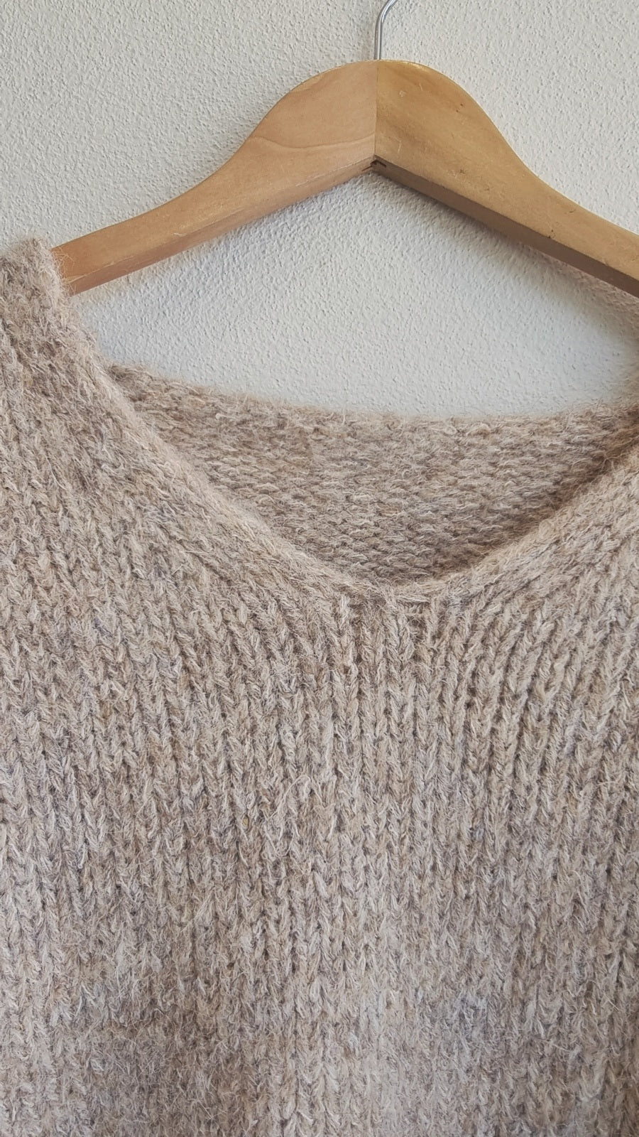 Close-up texture of soft beige wool blend knit sweater