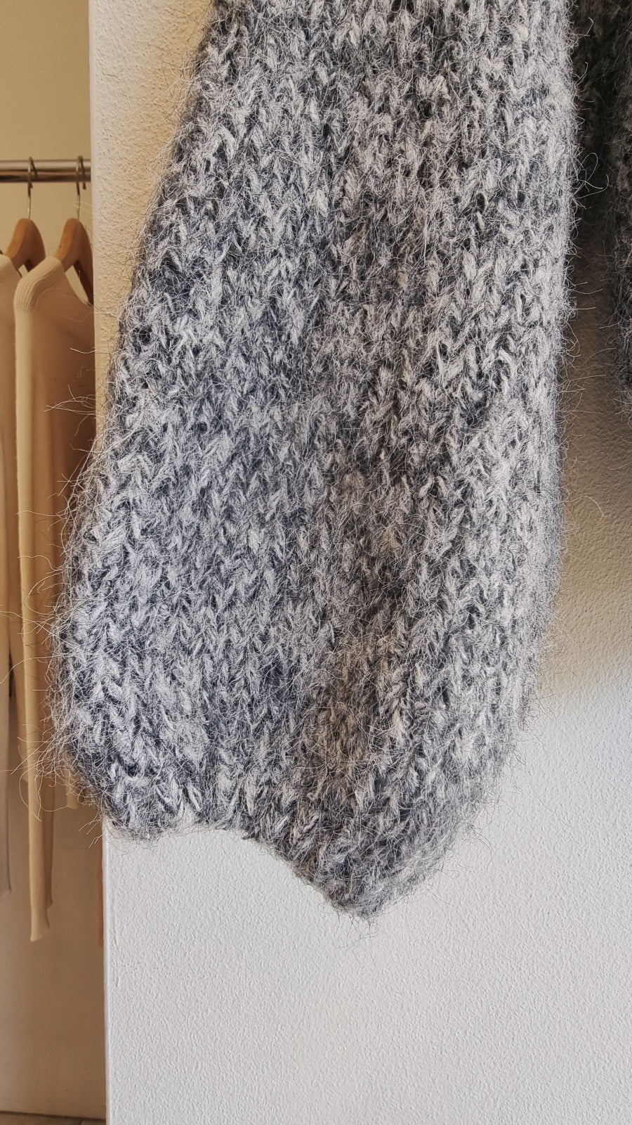 Close-up texture of soft grey wool blend knit sweater